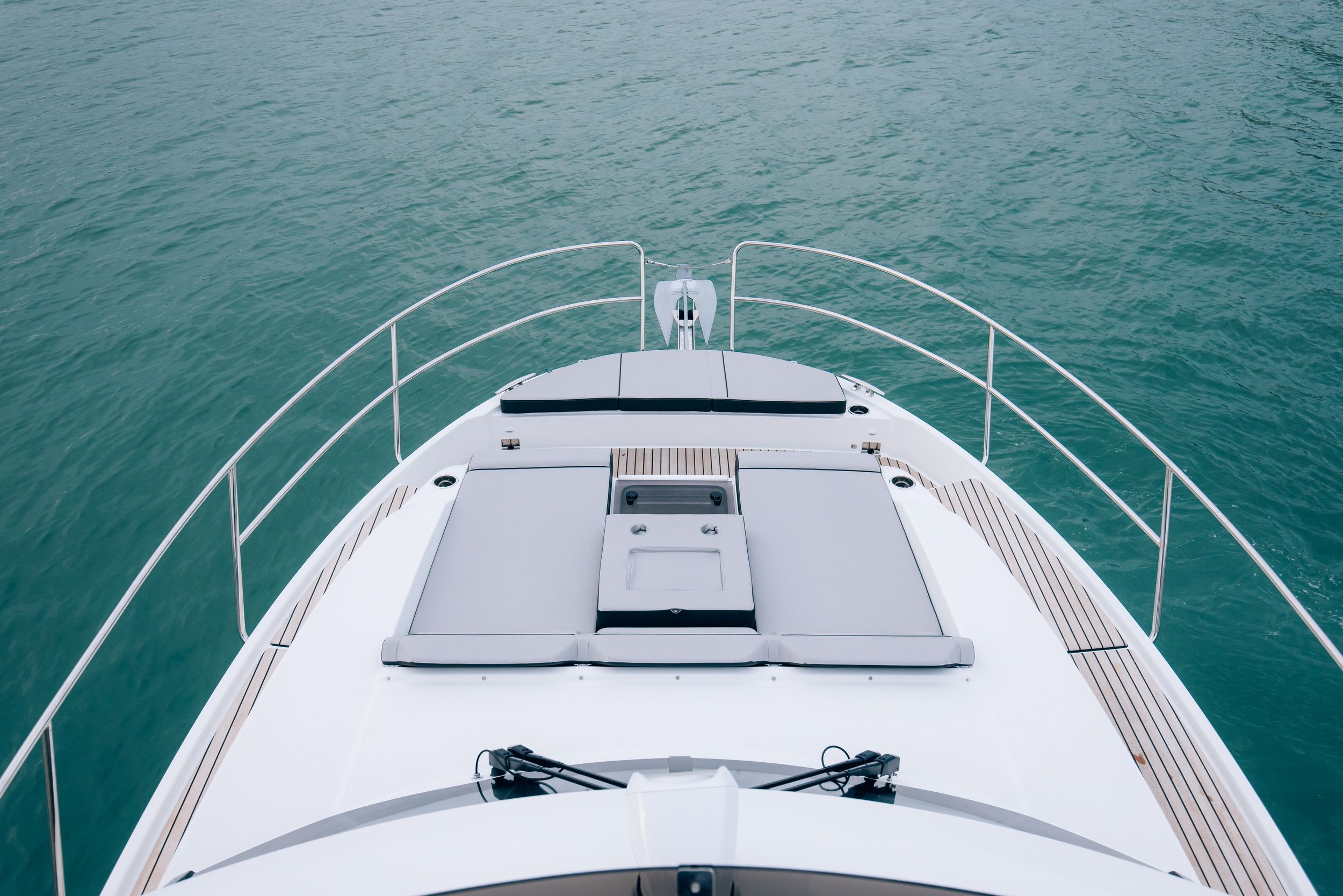 Aerial view of the bow of the Jeanneau Merry Fisher 1095 Fly Serie2 motor yacht with the anchor and sunbathing mats on the foredeck.