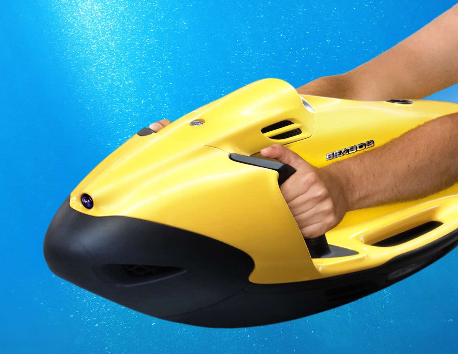 A yellow Seabob F5SR watercraft held by its operator in the water.