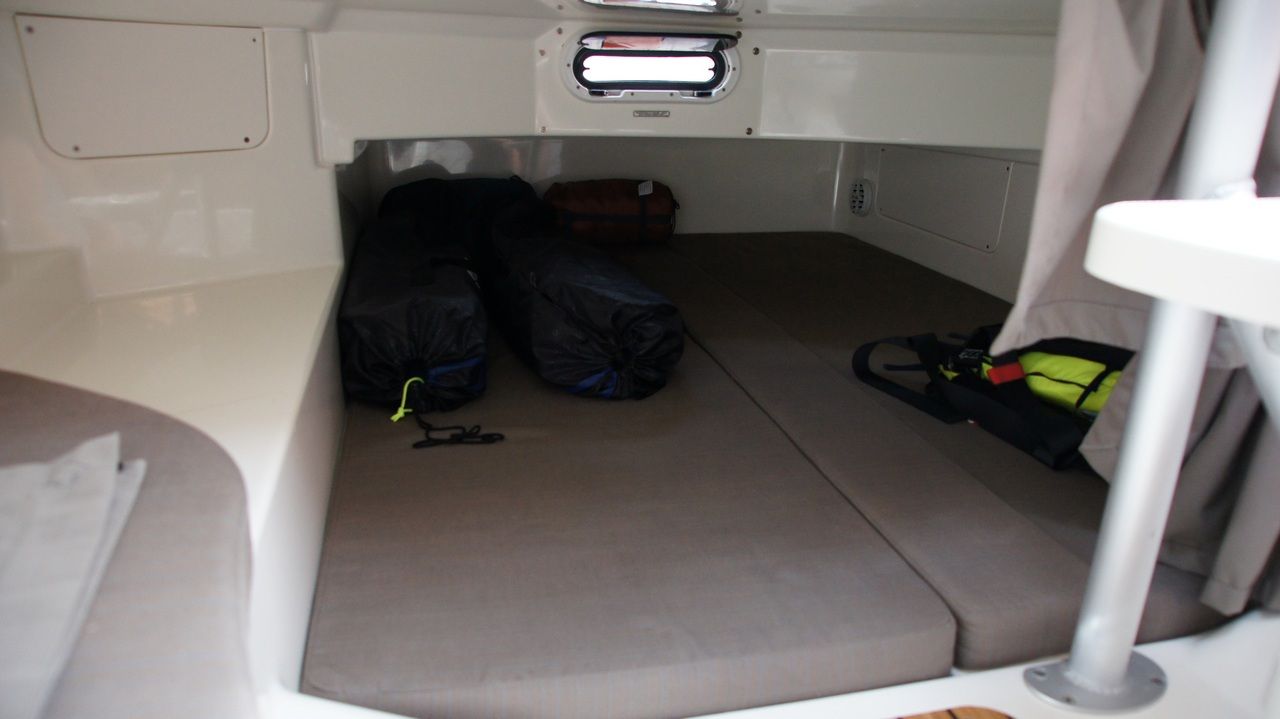 Interior of the bow cabin of the Uttern D77 with the berths made up and a hull window.