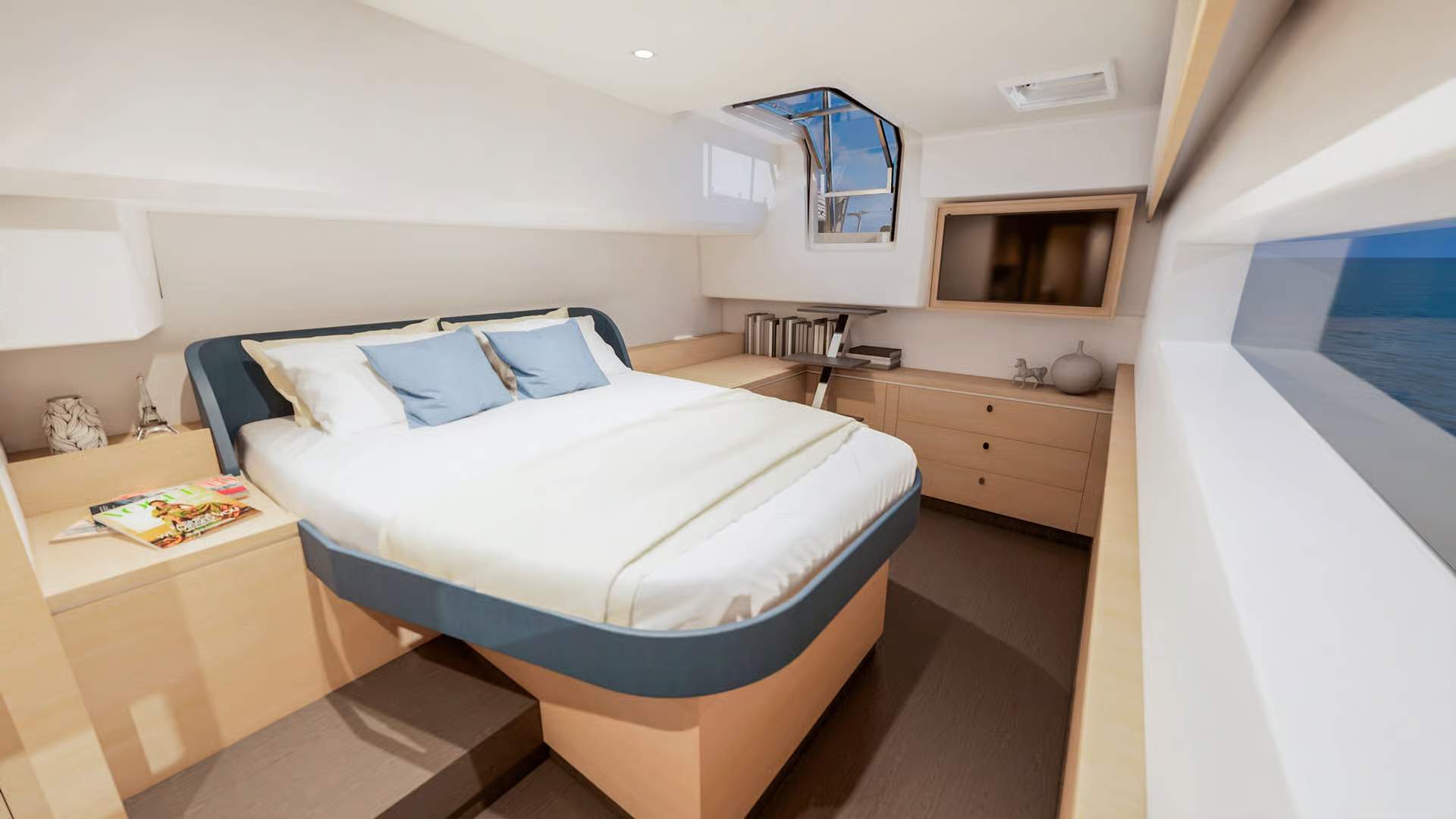 Interior of the owner's cabin on the Fountaine Pajot FP48 catamaran with a large bed, desk and TV.