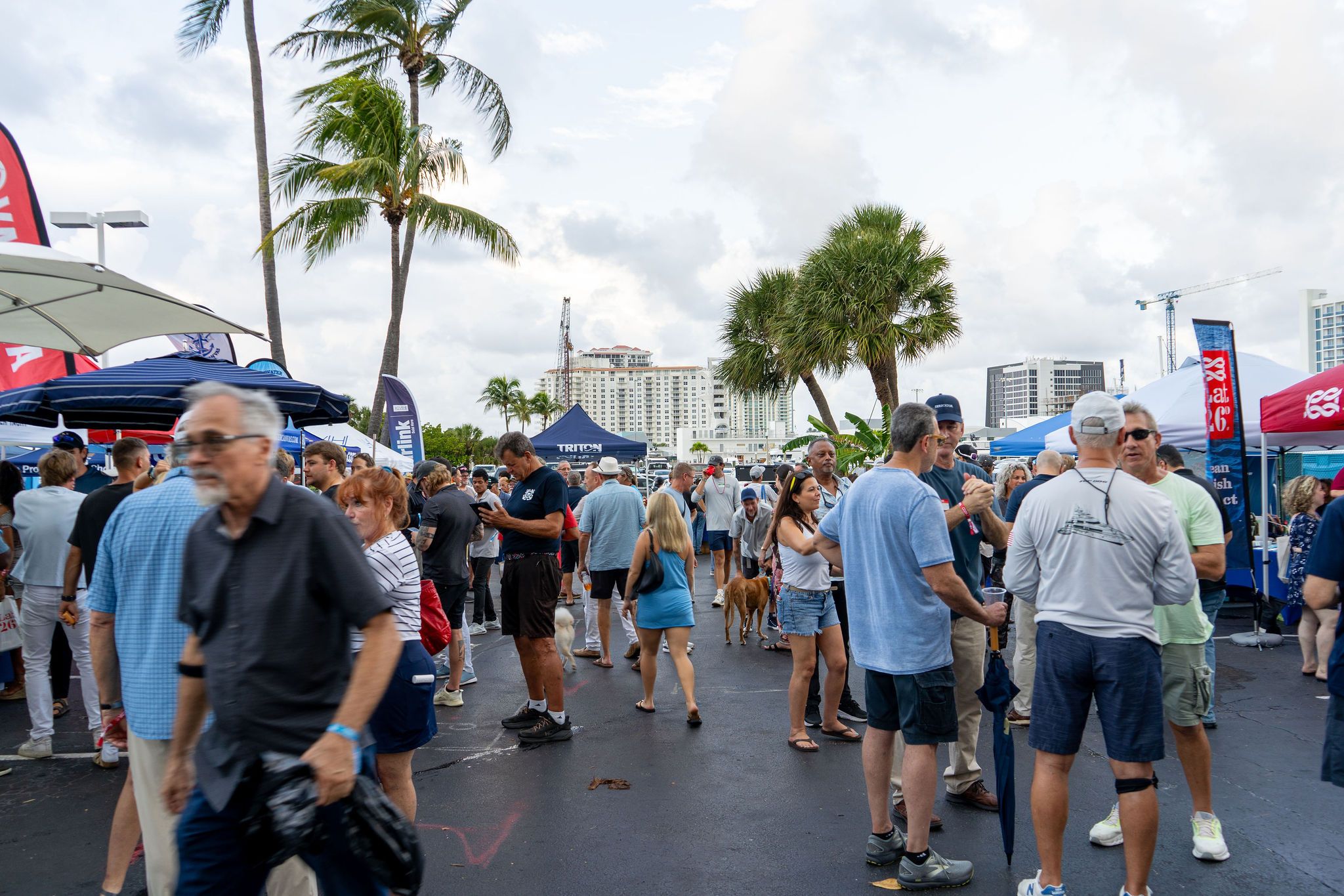 Guests in candid and group photos at The Triton's Fall Triton Expo at Bahia Mar Yachting Center.