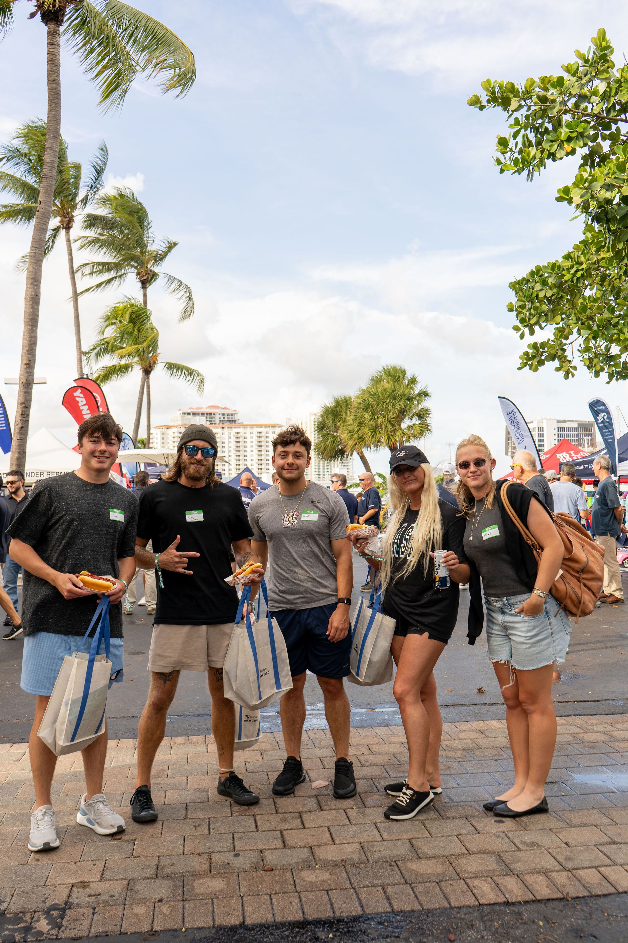 Guests in candid and group photos at The Triton's Fall Triton Expo at Bahia Mar Yachting Center.