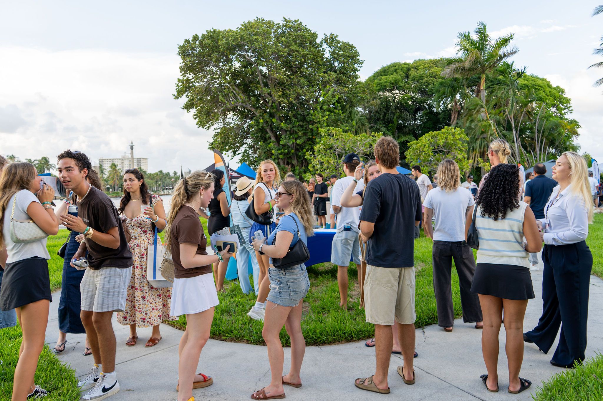 Guests in candid and group photos at The Triton's Fall Triton Expo at Bahia Mar Yachting Center.