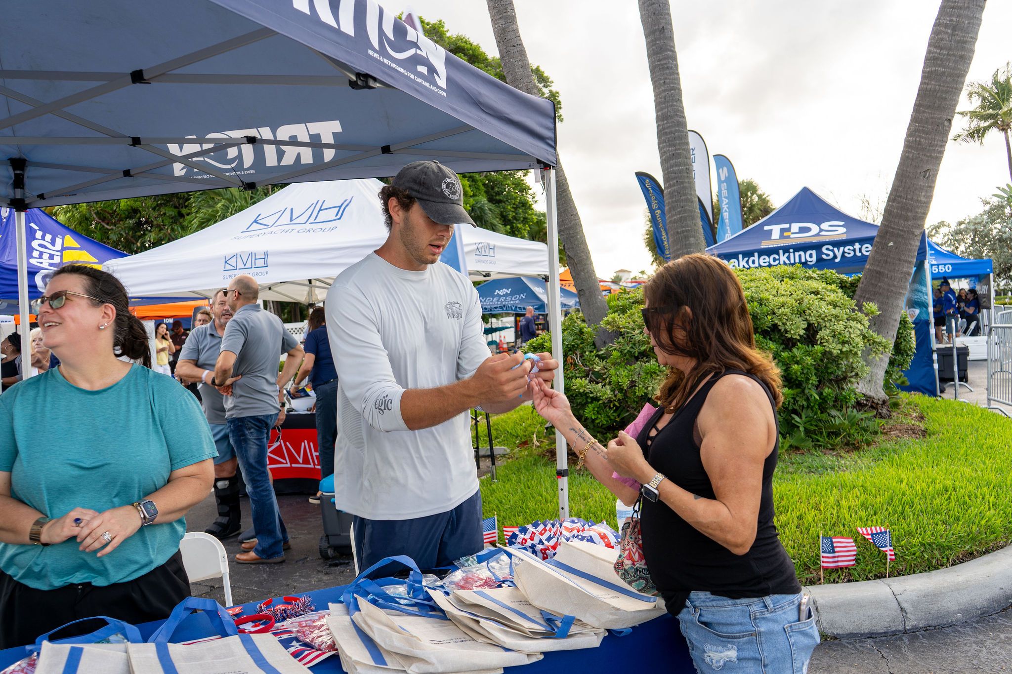Guests in candid and group photos at The Triton's Fall Triton Expo at Bahia Mar Yachting Center.