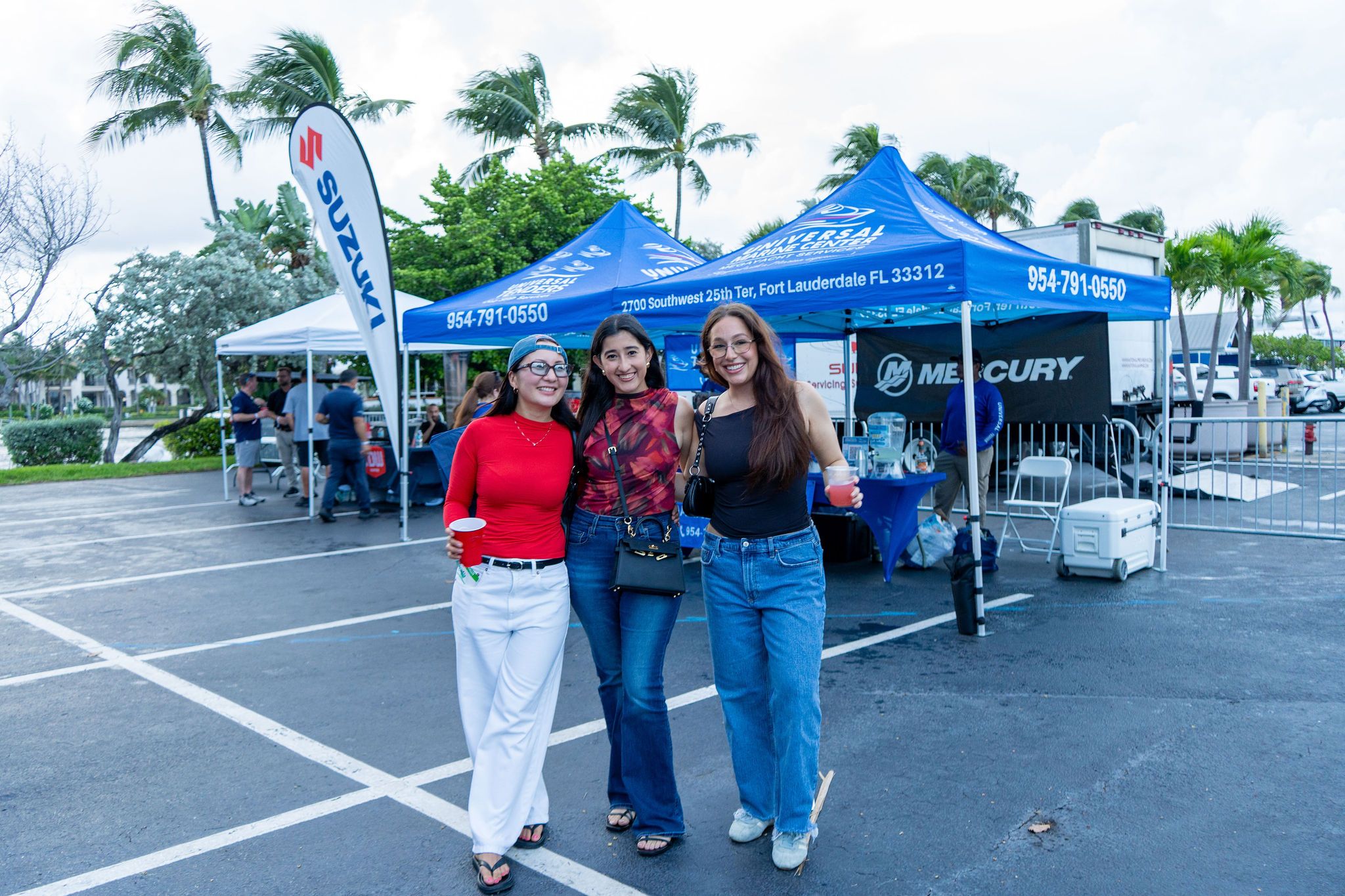 Guests in candid and group photos at The Triton's Fall Triton Expo at Bahia Mar Yachting Center.