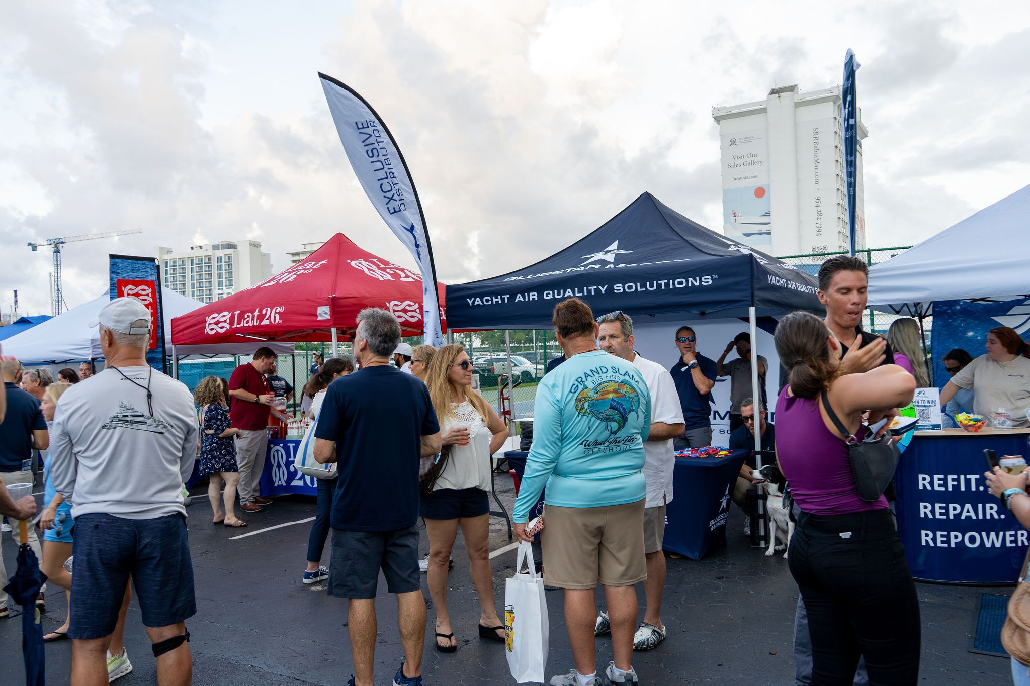 Guests in candid and group photos at The Triton's Fall Triton Expo at Bahia Mar Yachting Center.