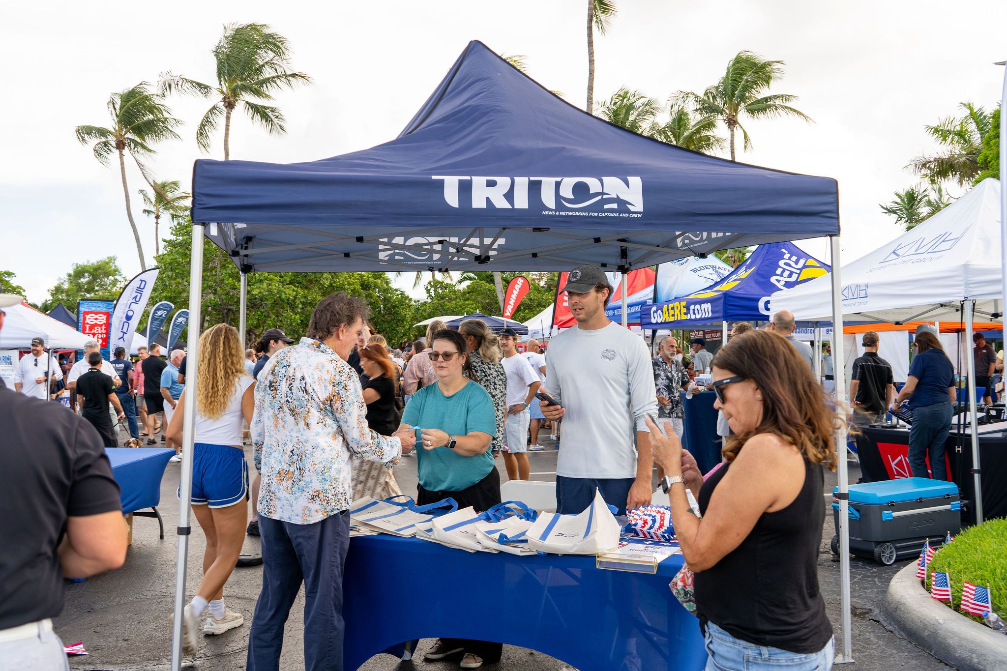 Guests in candid and group photos at The Triton's Fall Triton Expo at Bahia Mar Yachting Center.