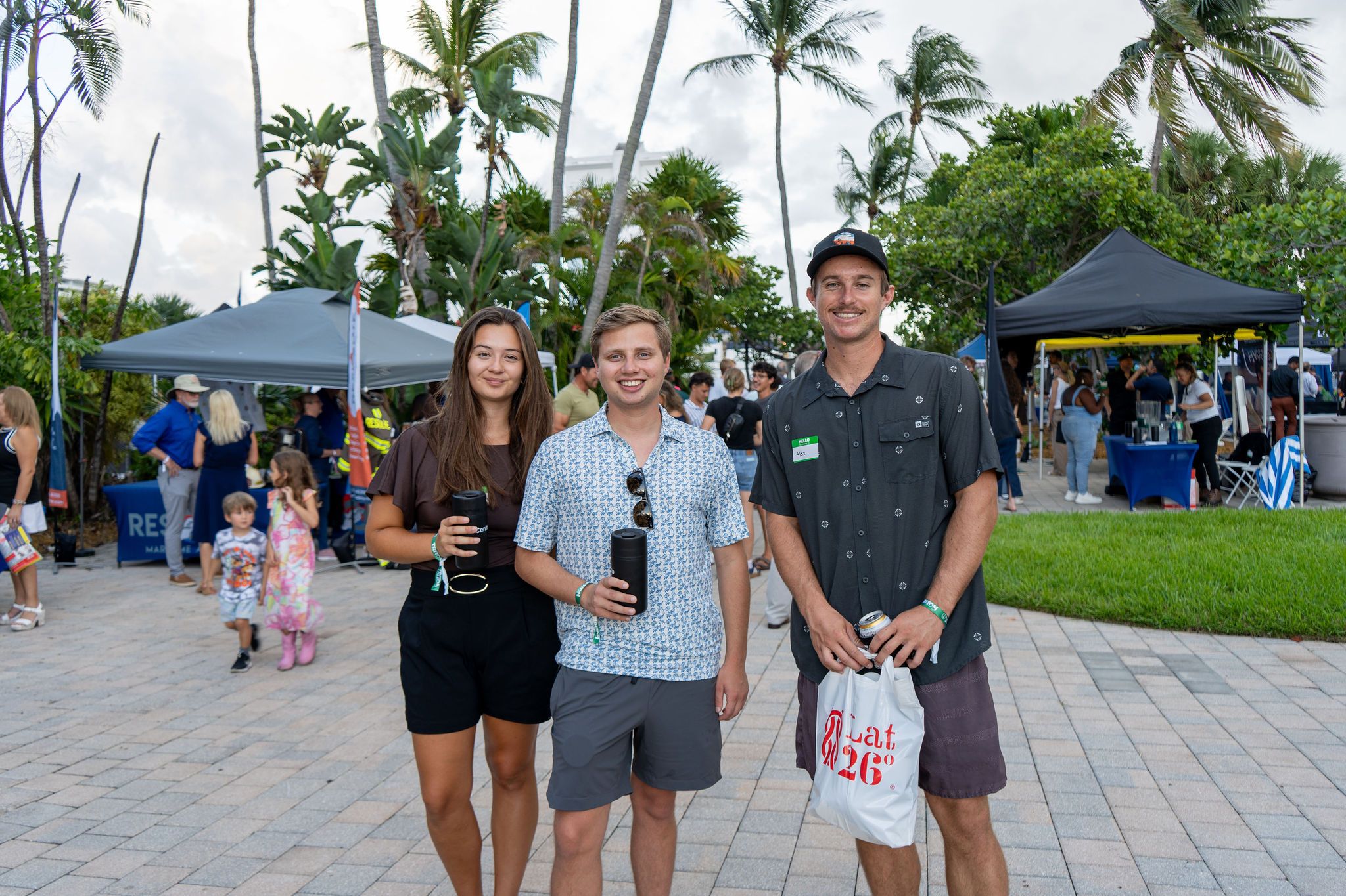 Guests in candid and group photos at The Triton's Fall Triton Expo at Bahia Mar Yachting Center.