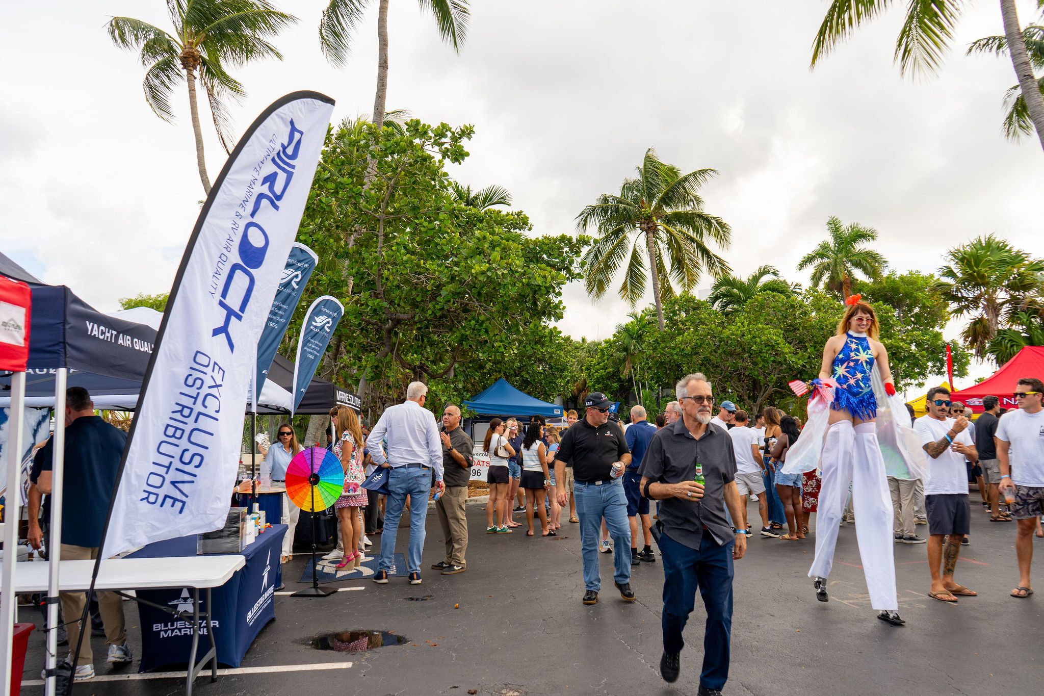 Guests in candid and group photos at The Triton's Fall Triton Expo at Bahia Mar Yachting Center.