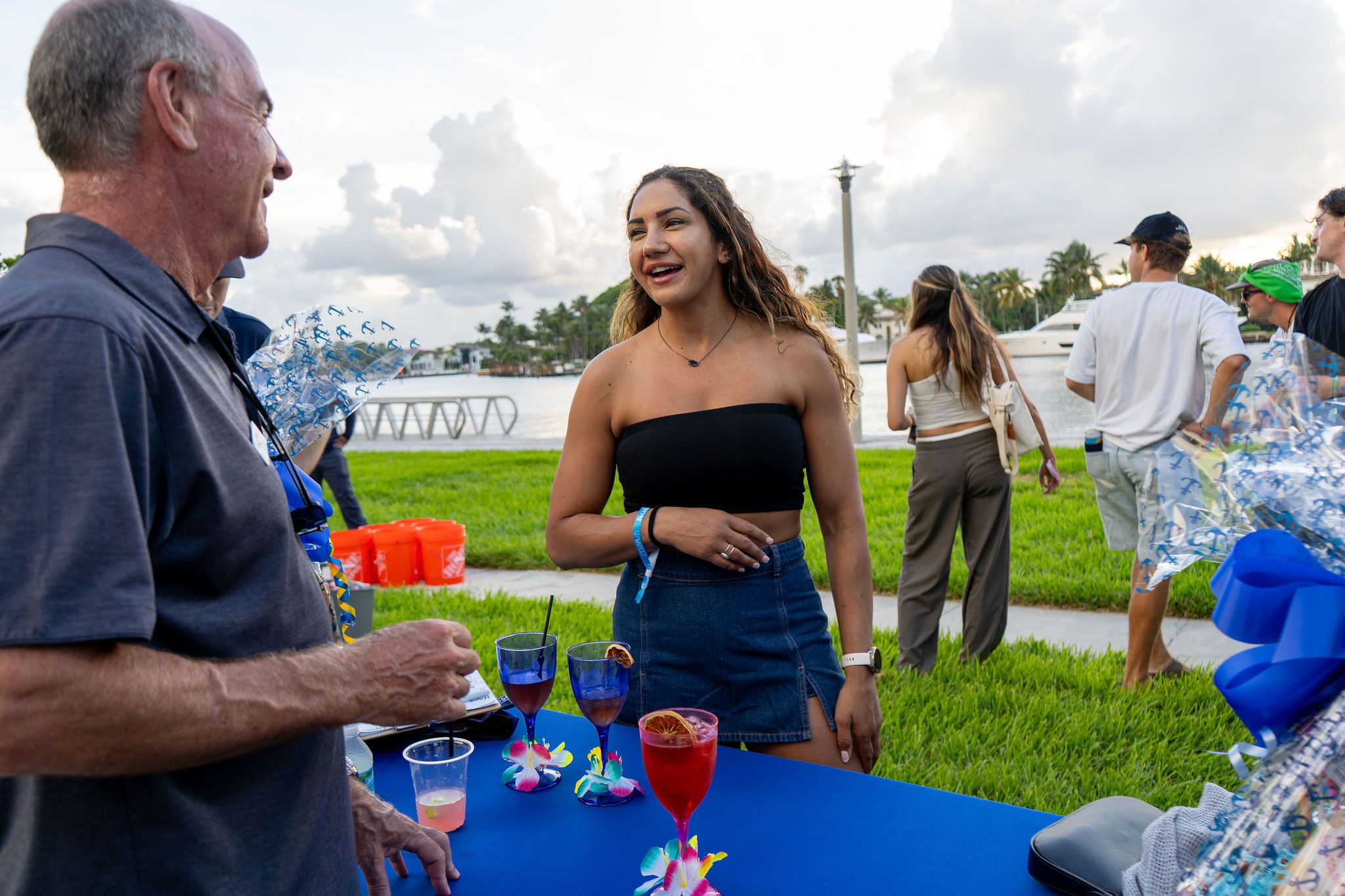 Guests in candid and group photos at The Triton's Fall Triton Expo at Bahia Mar Yachting Center.