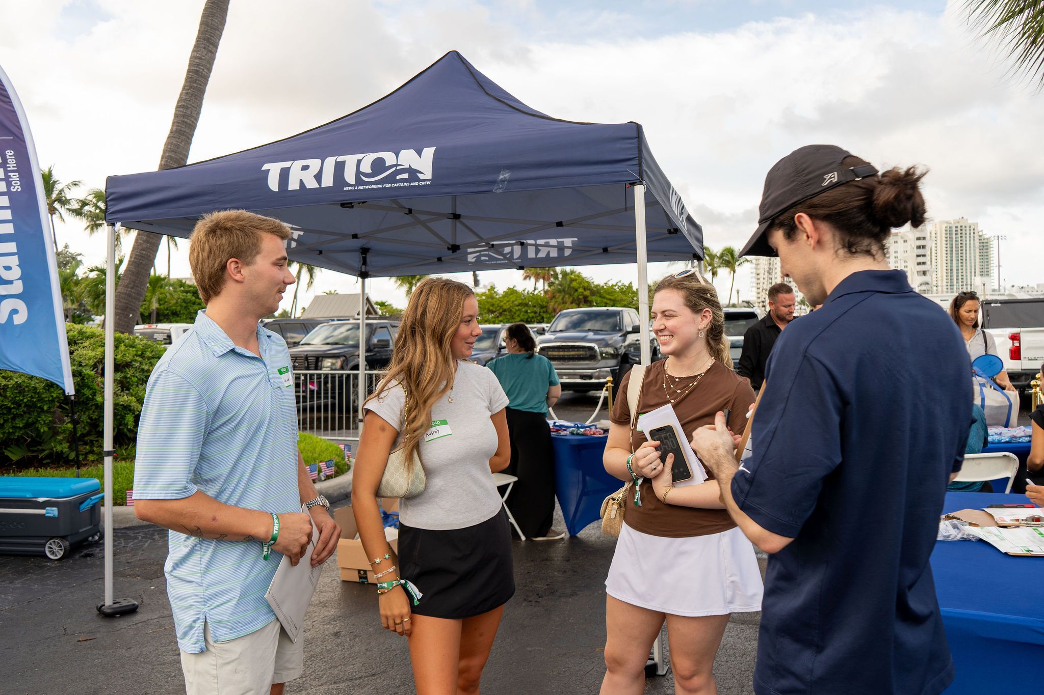 Guests in candid and group photos at The Triton's Fall Triton Expo at Bahia Mar Yachting Center.
