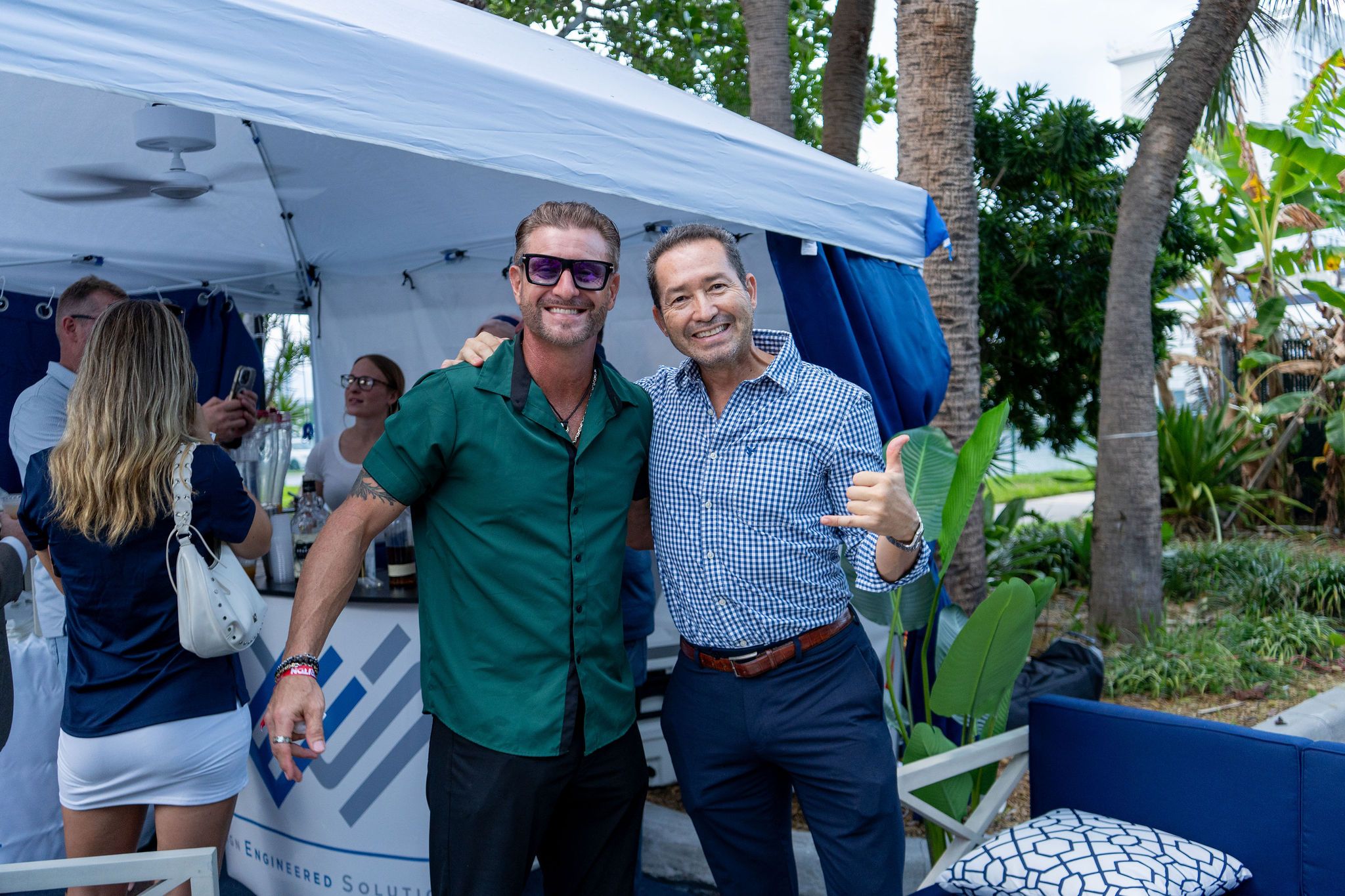 Guests in candid and group photos at The Triton's Fall Triton Expo at Bahia Mar Yachting Center.