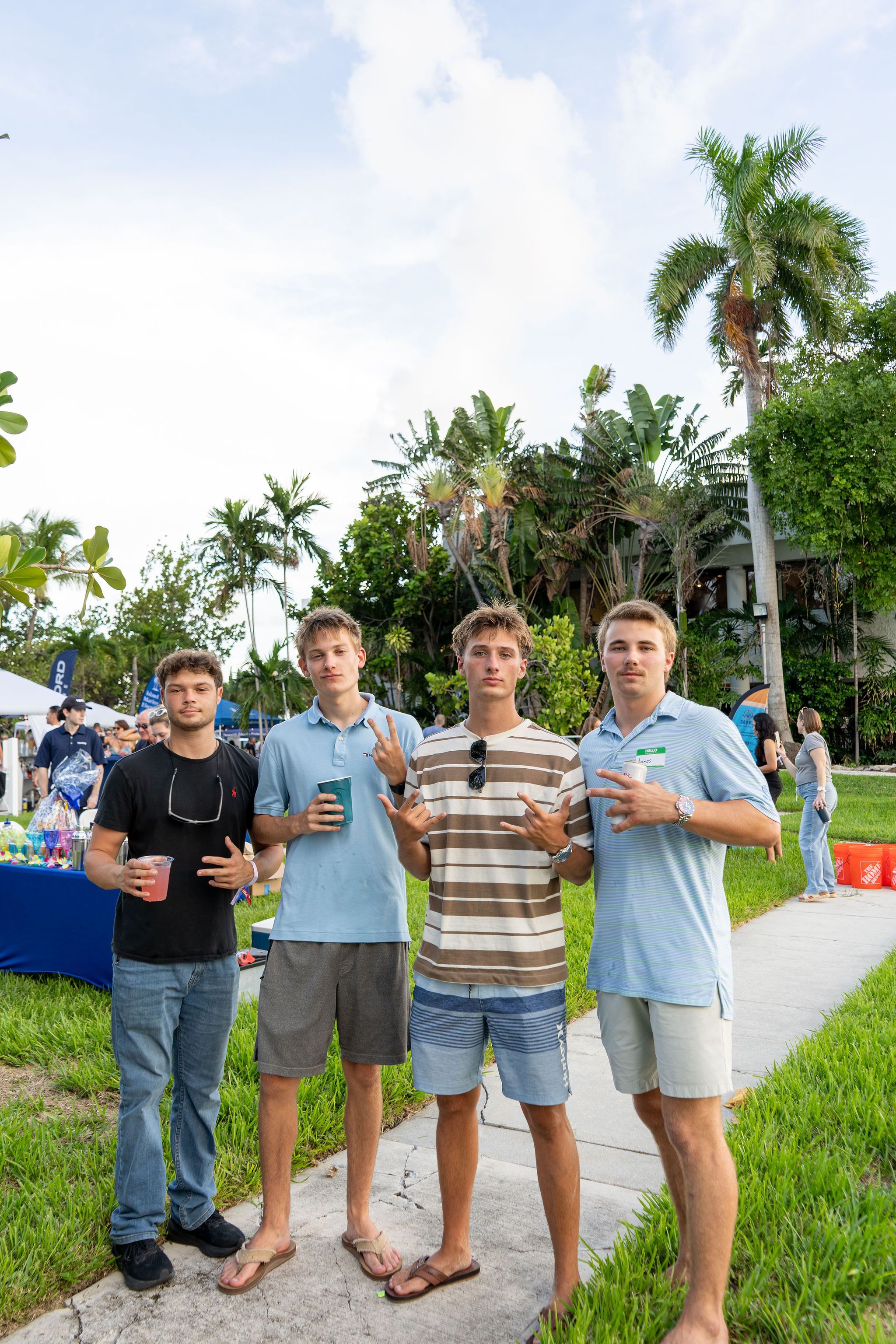 Guests in candid and group photos at The Triton's Fall Triton Expo at Bahia Mar Yachting Center.