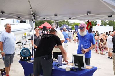 Guests networking at The Triton's Crew, Captains & Connections event at Nautical Ventures Marina.