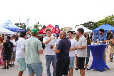 Guests networking at The Triton's Crew, Captains & Connections event at Nautical Ventures Marina.
