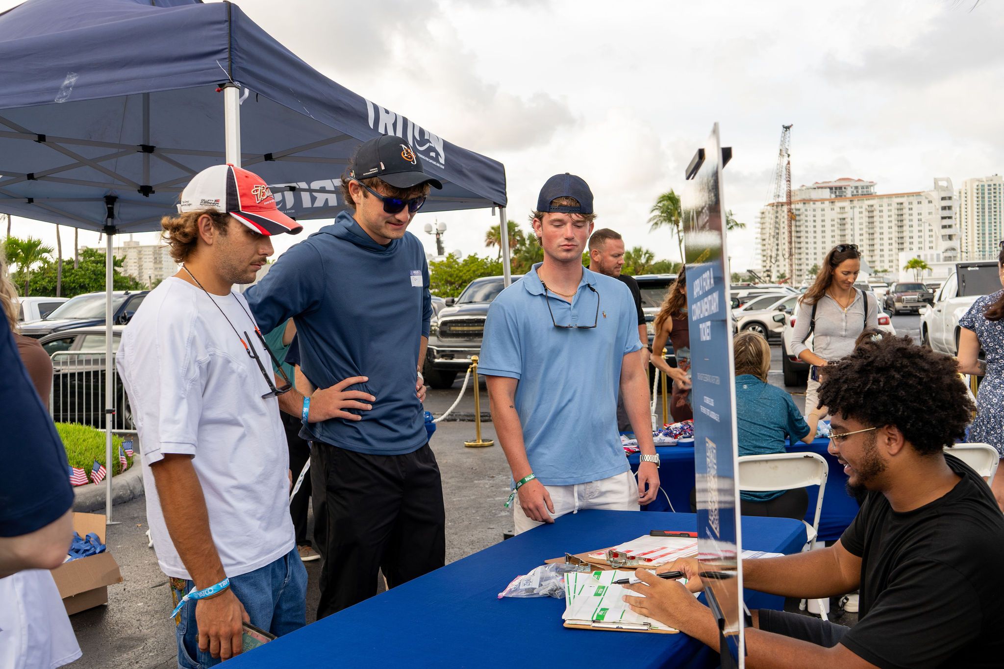 Guests in candid and group photos at The Triton's Fall Triton Expo at Bahia Mar Yachting Center.