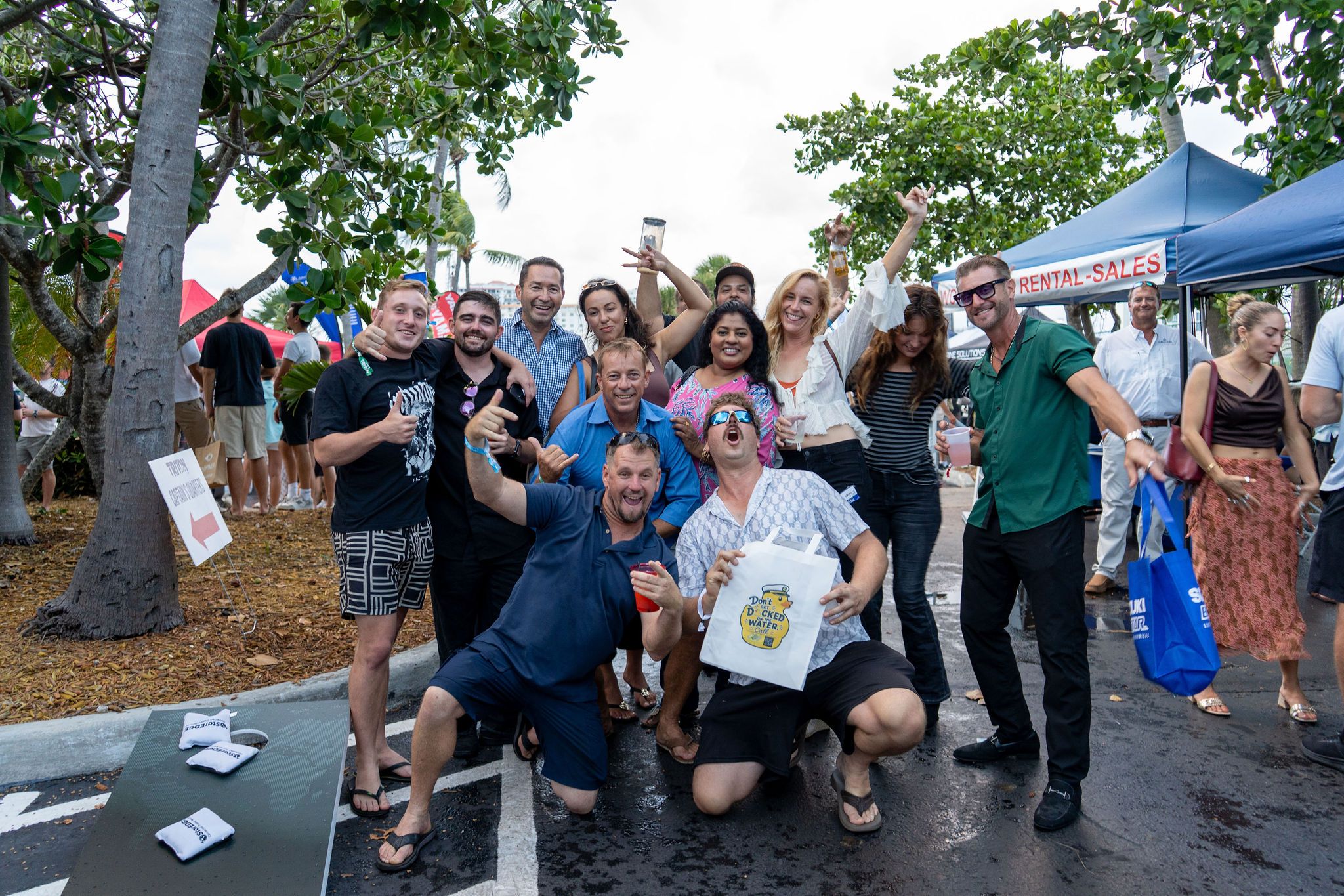Guests in candid and group photos at The Triton's Fall Triton Expo at Bahia Mar Yachting Center.