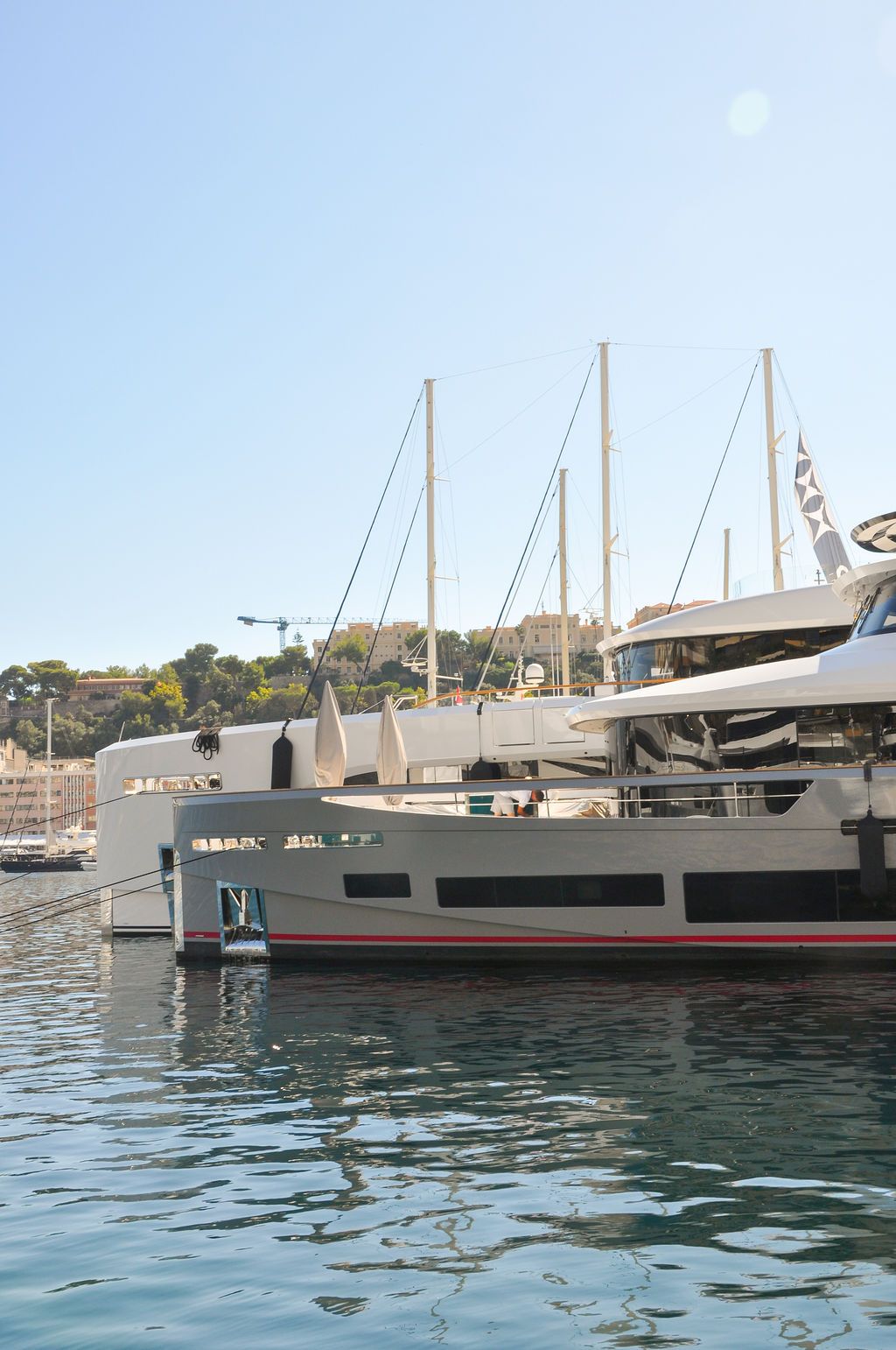 Yachts and crew on the docks at the 2026 Monaco Yacht Show in Port Hercule, Monaco.
