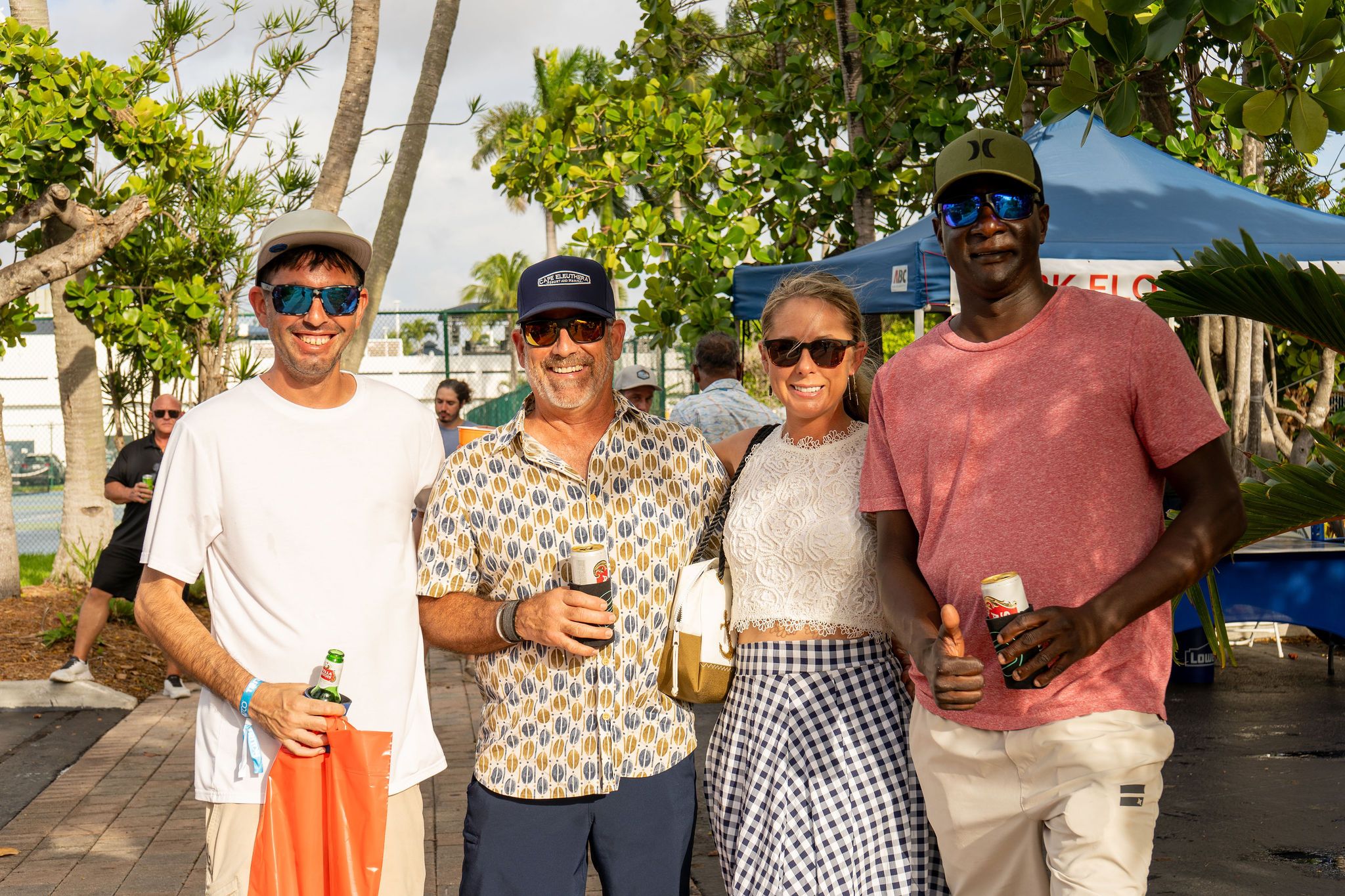 Guests in candid and group photos at The Triton's Fall Triton Expo at Bahia Mar Yachting Center.
