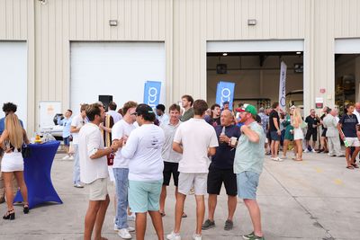 Guests networking at The Triton's Crew, Captains & Connections event at Nautical Ventures Marina.