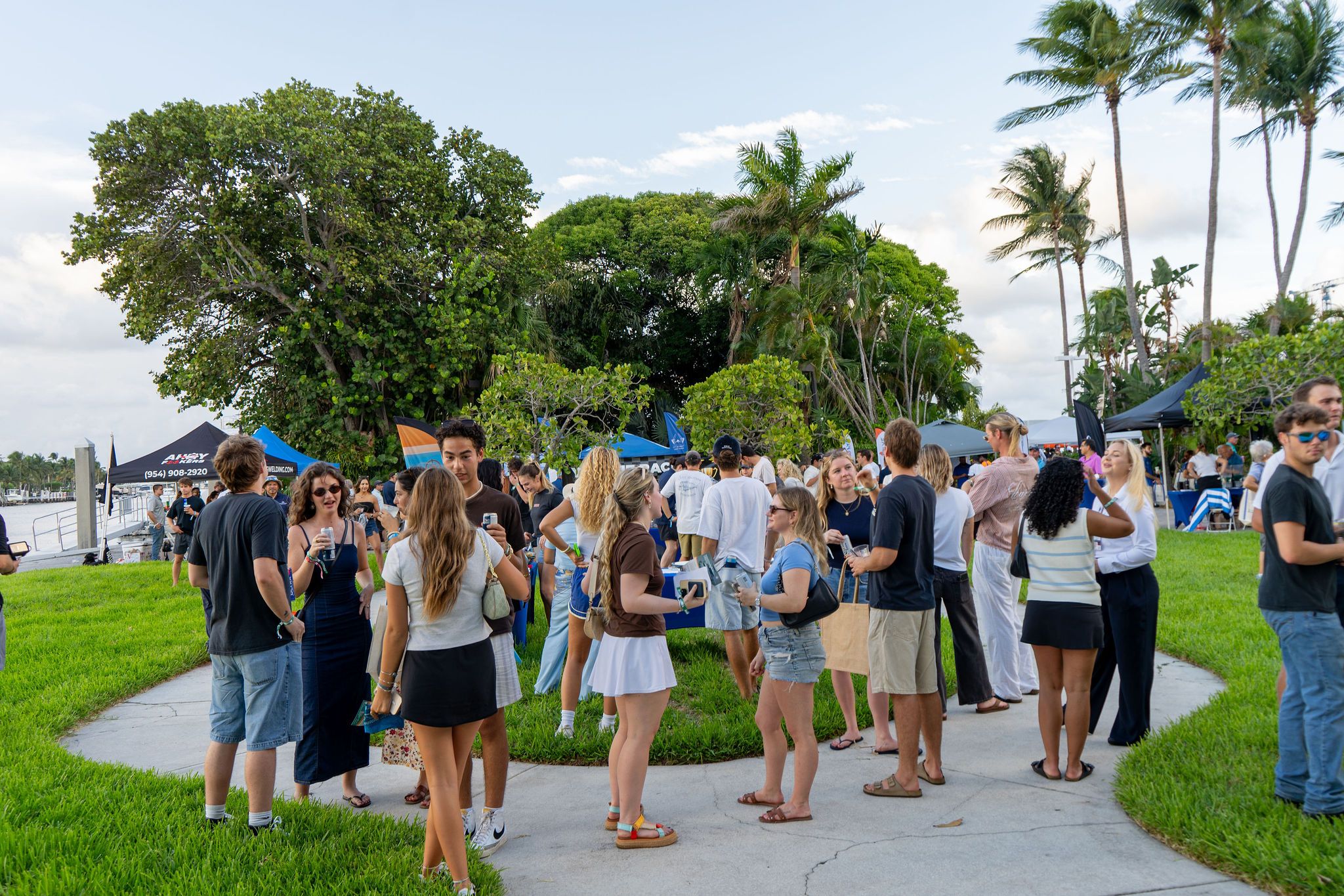 Guests in candid and group photos at The Triton's Fall Triton Expo at Bahia Mar Yachting Center.