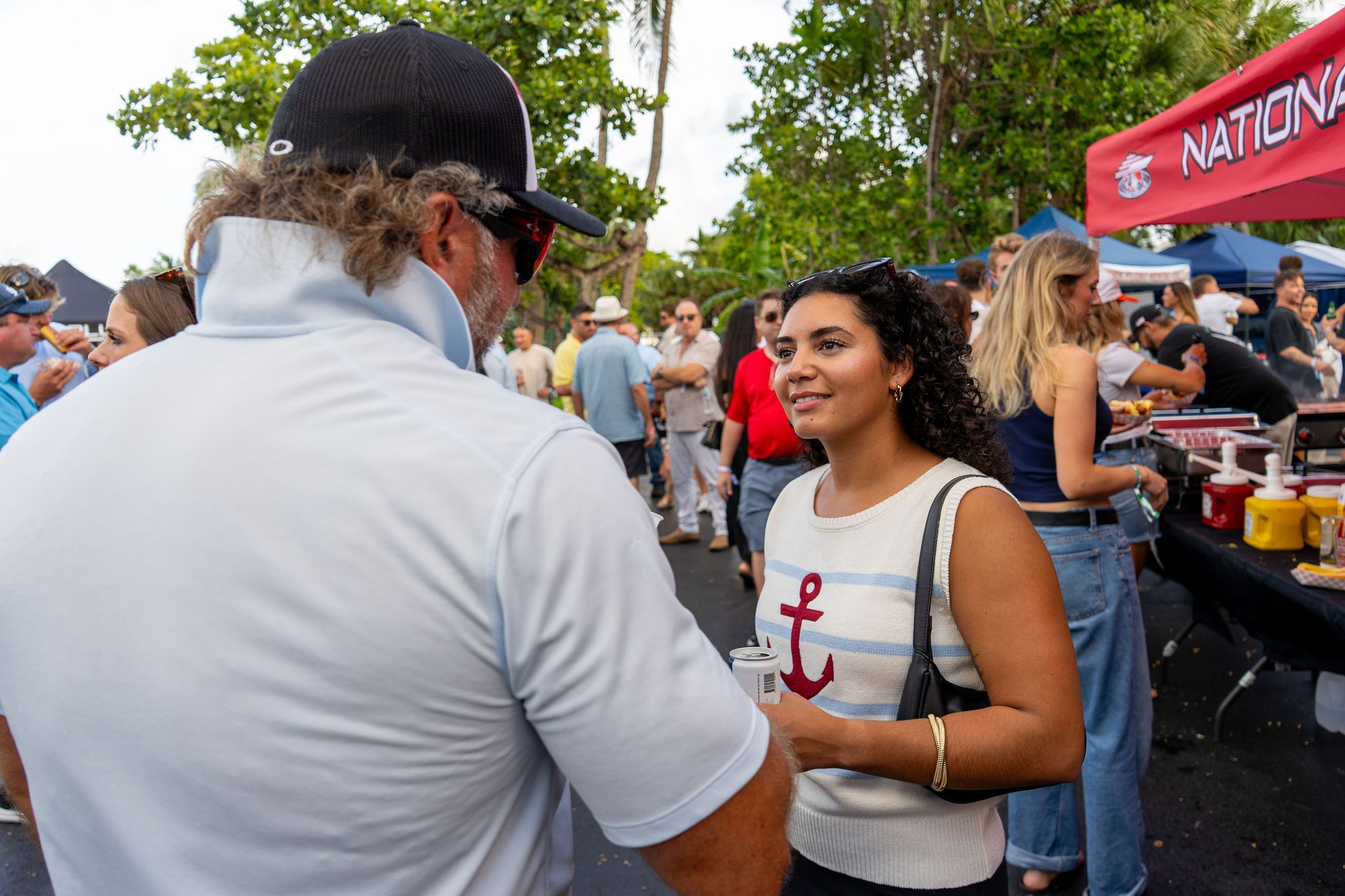 Guests in candid and group photos at The Triton's Fall Triton Expo at Bahia Mar Yachting Center.
