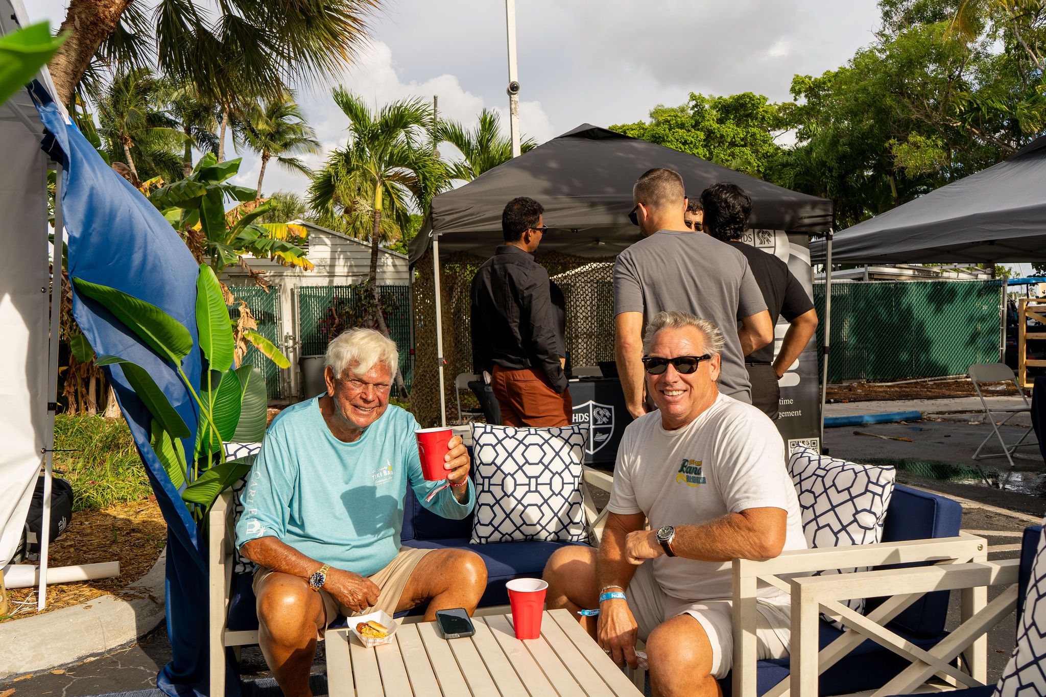Guests in candid and group photos at The Triton's Fall Triton Expo at Bahia Mar Yachting Center.