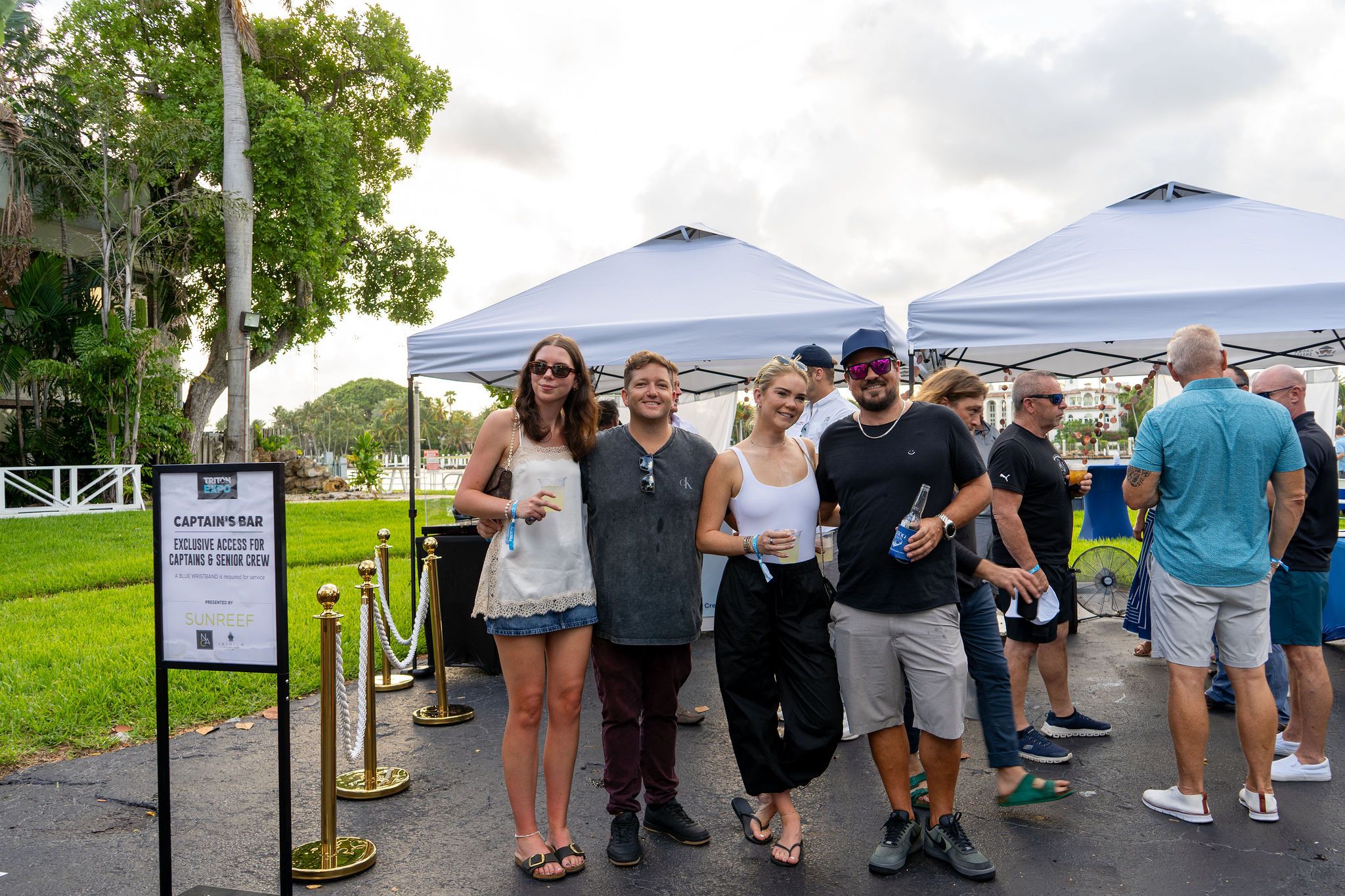 Guests in candid and group photos at The Triton's Fall Triton Expo at Bahia Mar Yachting Center.