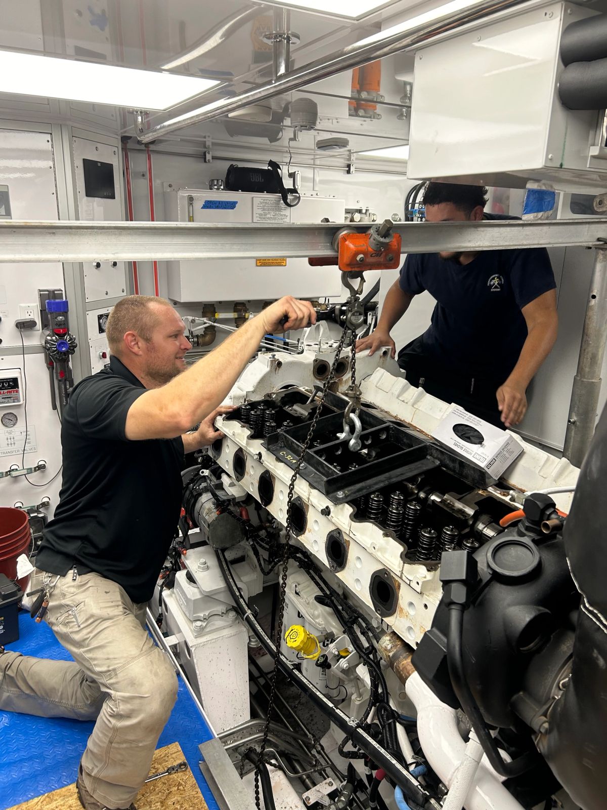 A yacht engineer fixing an engine