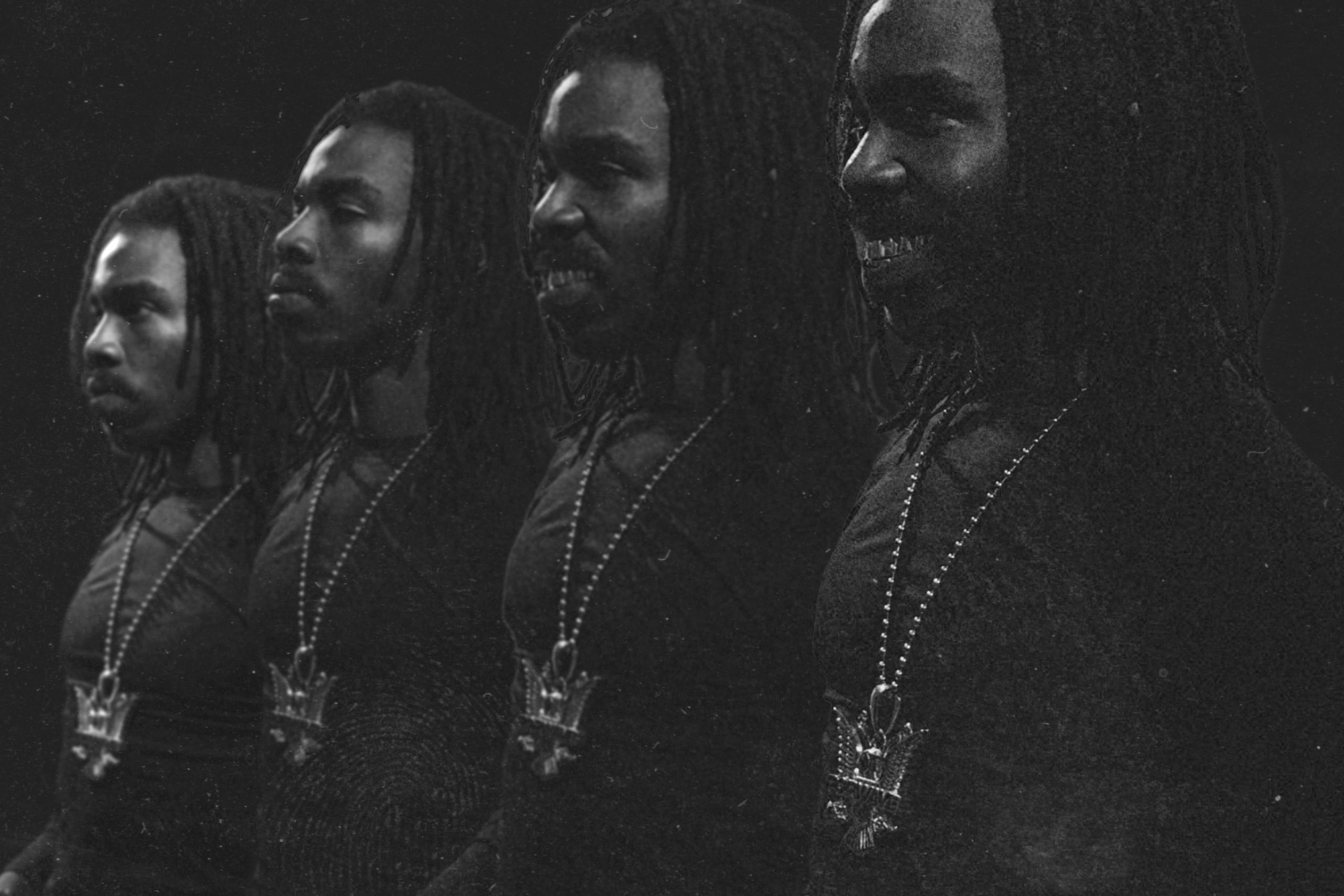 Black-and-white album-style artwork featuring four overlapping portraits of the same dreadlocked man in profile, wearing dark clothing and a large pendant necklace, with a grainy, moody texture and a “Parental Advisory” label in the top-left corner.