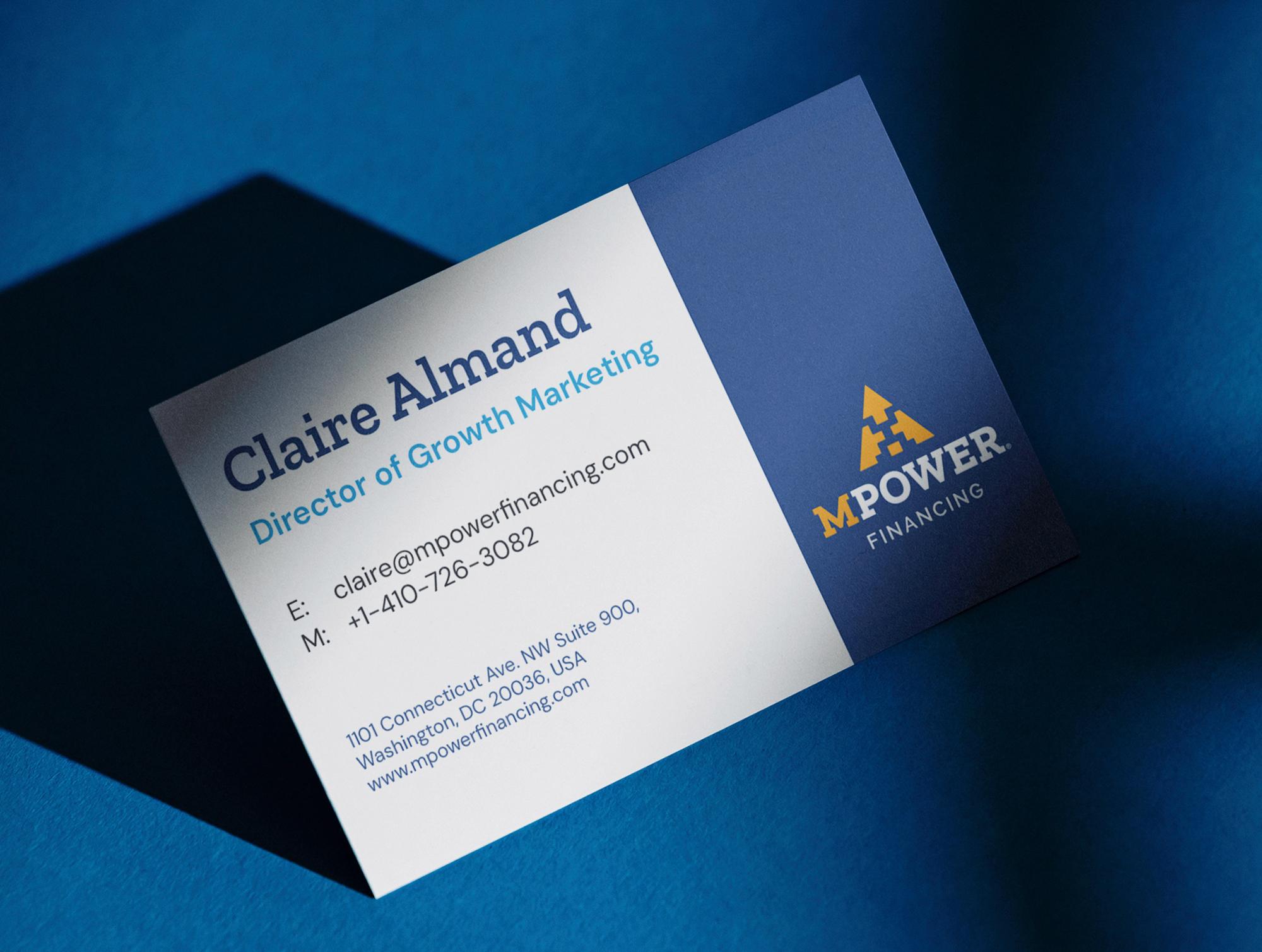 A business card for Claire Almand, MPOWER’s Director of Growth Marketing, lit on a blue ground with the mark and wordmark filling the right third.
