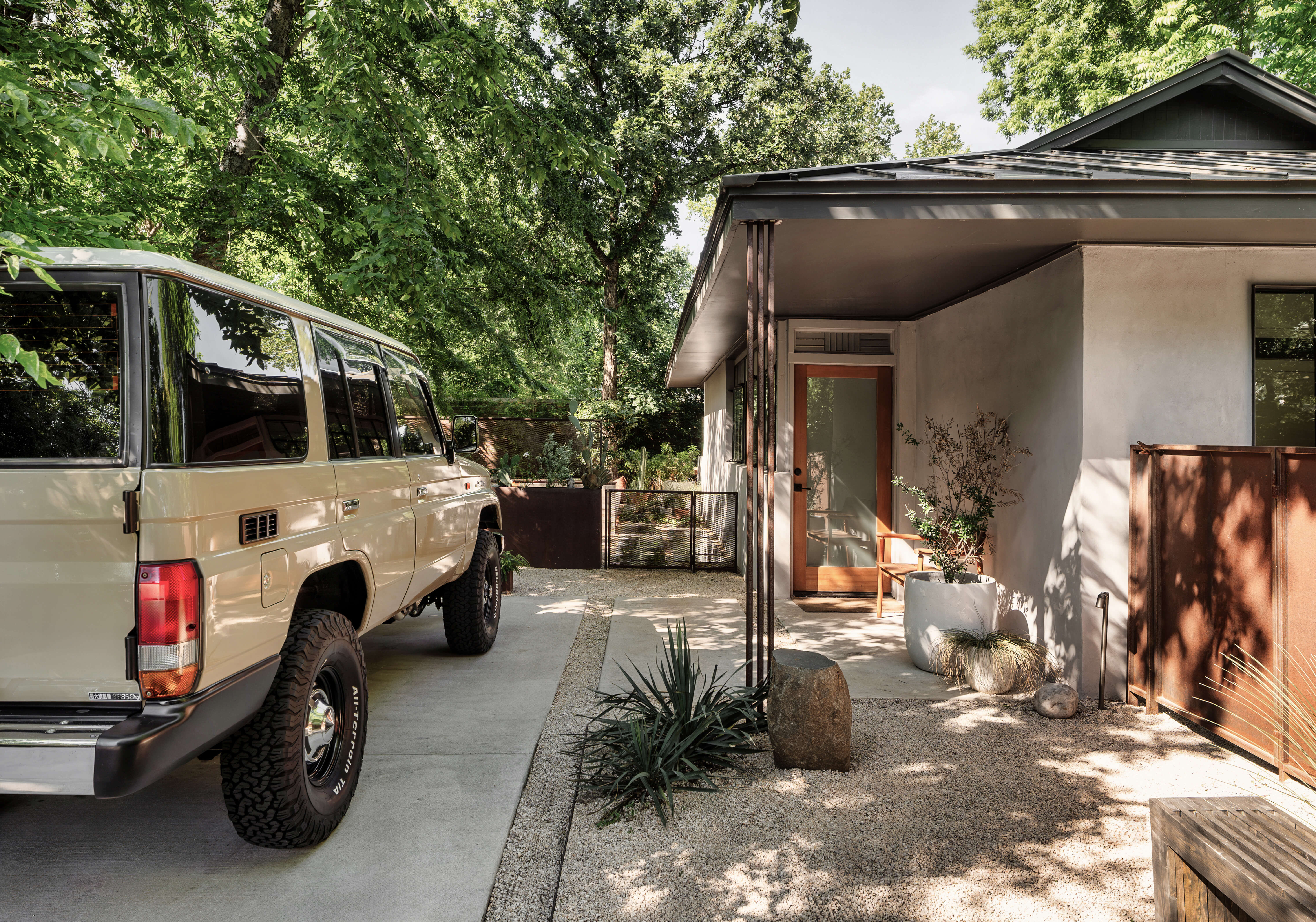 Golden Hour Pools Classic in Austin, featuring pool house exterior with agave landscaping and live oak canopy in Zilker