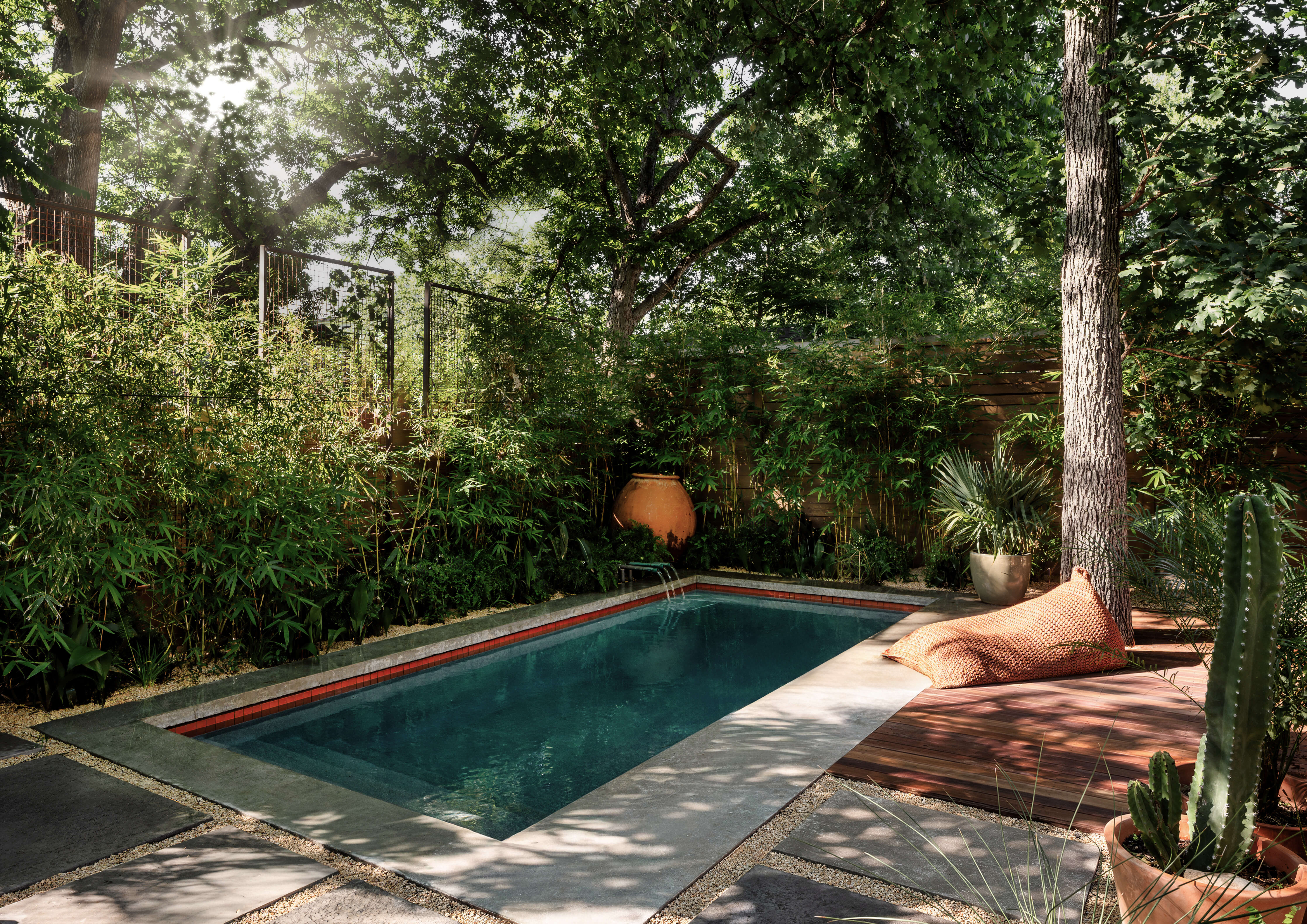 Golden Hour Pools Classic in Austin, featuring Classic gunite pool with spillway fountain and bamboo surround in Zilker