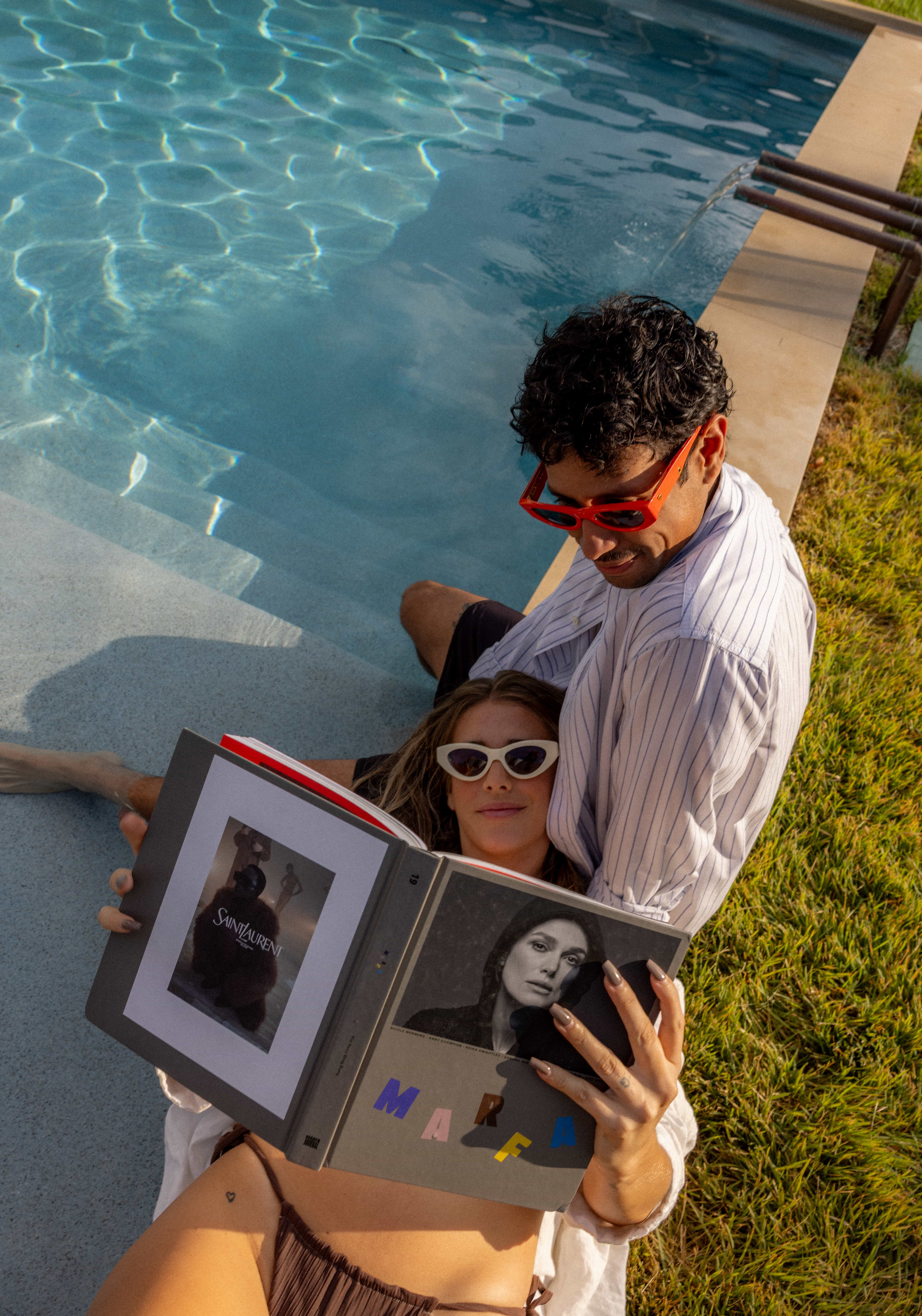 Golden Hour Pools Grand in Waco, featuring couple reading on poolside loungers and gunite plaster finish