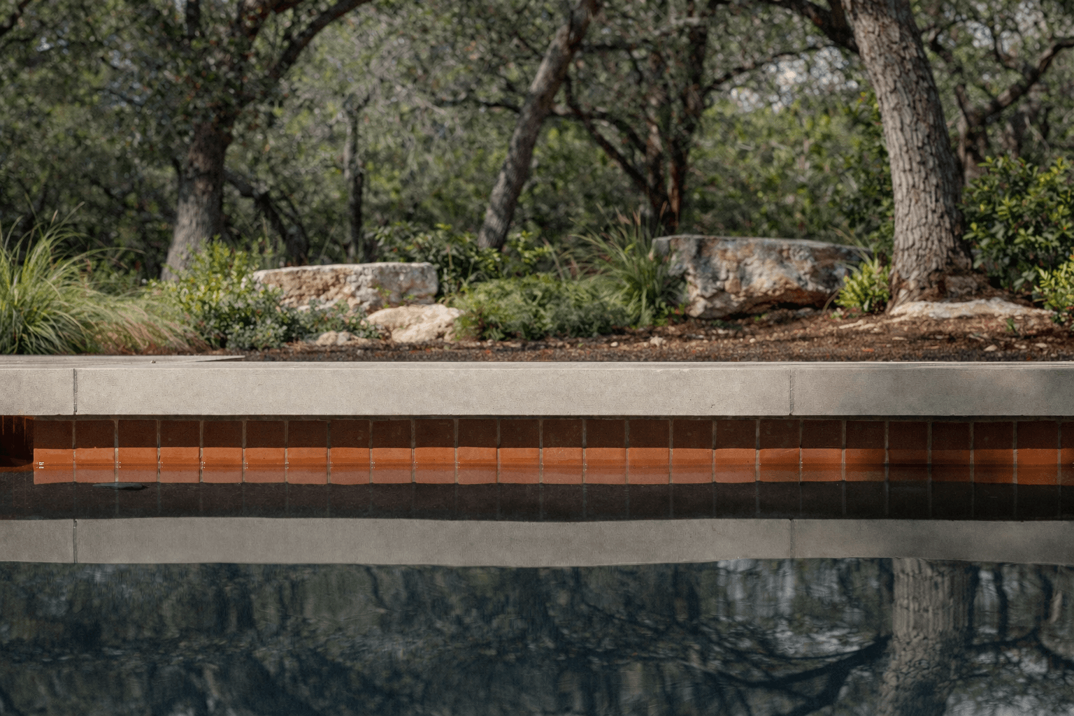 Golden Hour Pools Classic in Austin, featuring illuminated pool at nightfall and gunite plaster finish