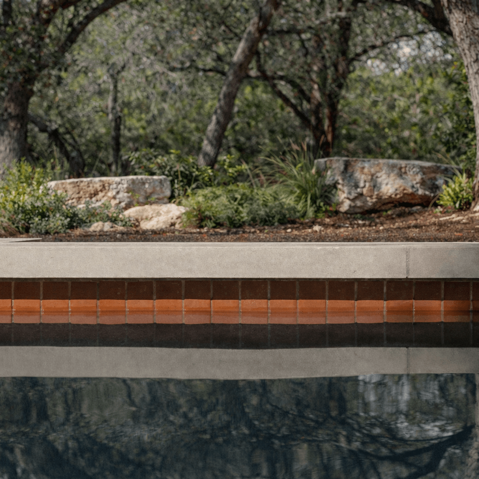 Golden Hour Pools Classic in Austin, featuring illuminated pool at nightfall and gunite plaster finish