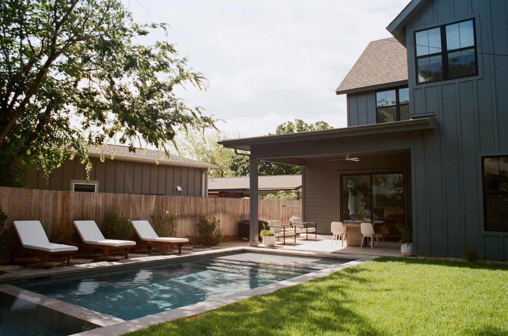 Golden Hour Pools Classic + Spa in Houston, featuring modern farmhouse with chaise lounges and gunite plaster finish