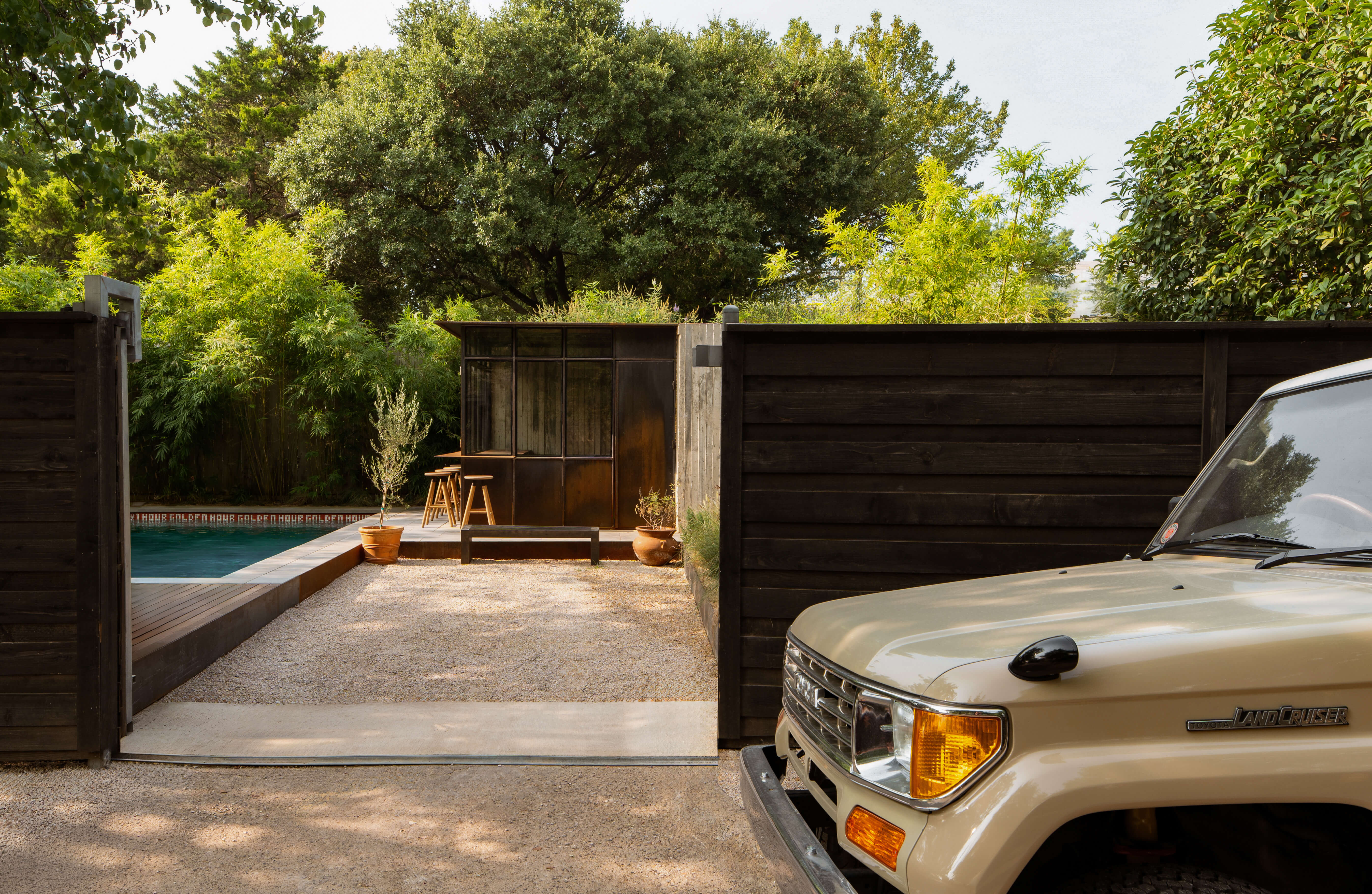 Entrance gate and driveway leading to the Golden Hour Dallas pool house