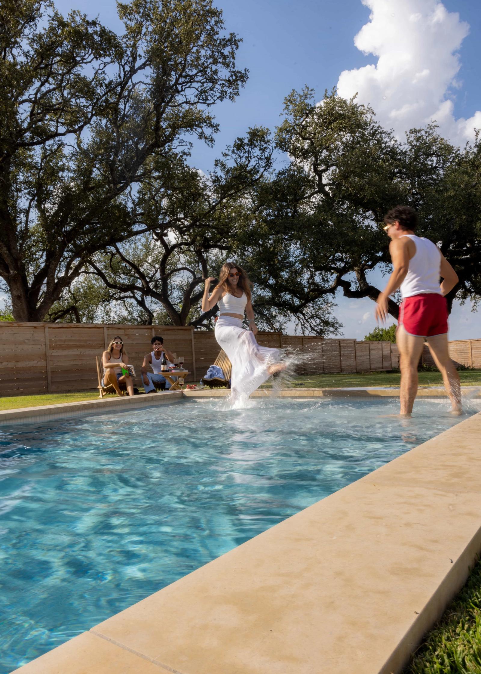 Golden Hour Pools Grand in Waco, featuring woman splashing at party and gunite plaster finish