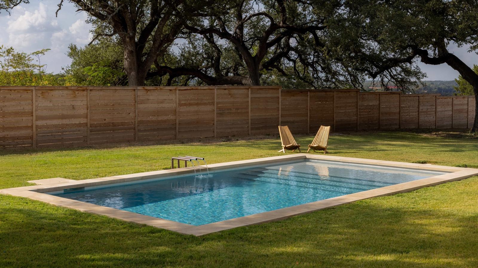 Golden Hour Pools Grand in Waco, featuring grand pool with heritage oaks and loungers and gunite plaster finish