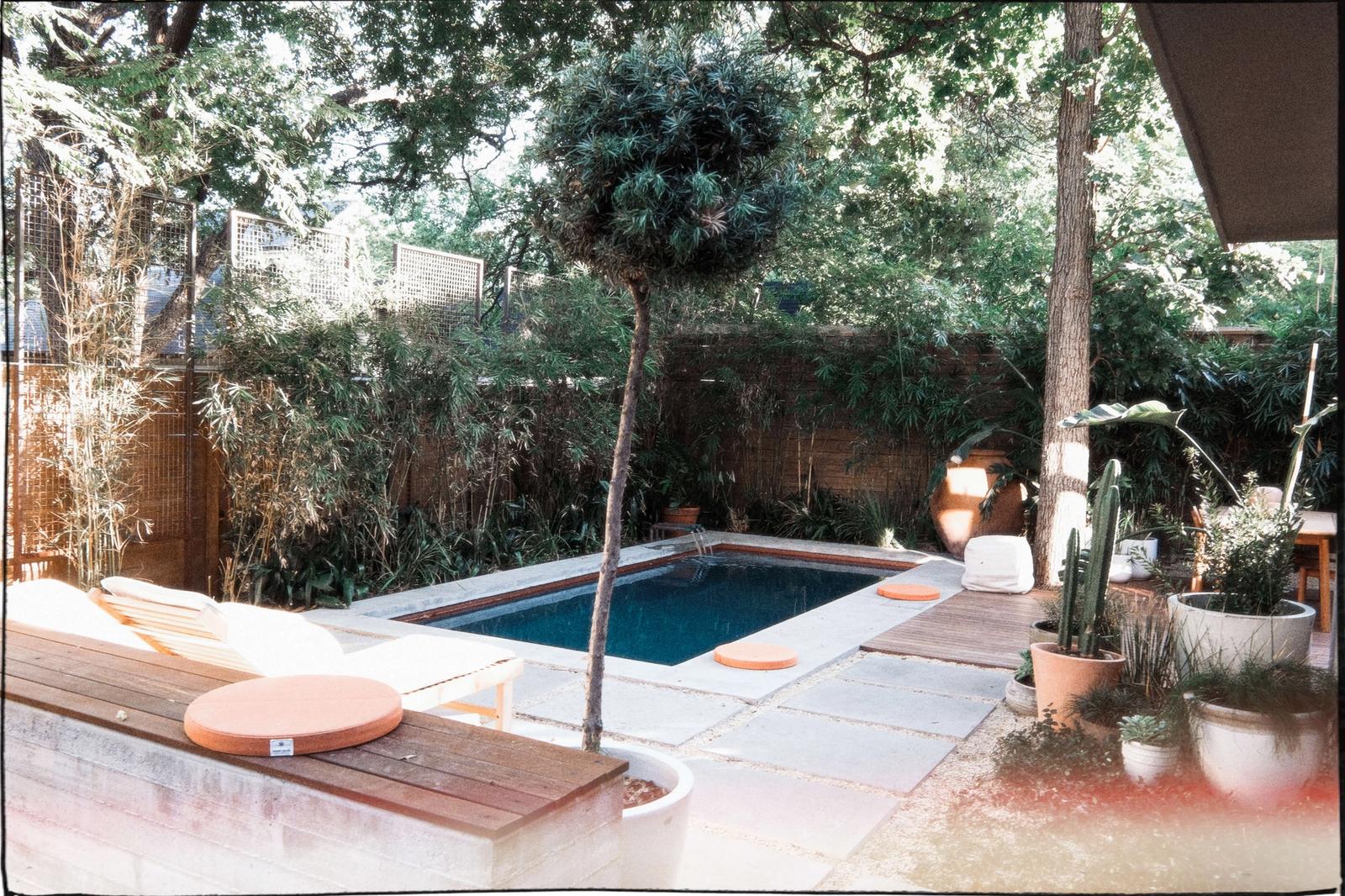 Golden Hour Pools Classic pool with Lueders stone coping and ipe wood deck in an Austin, Texas backyard
