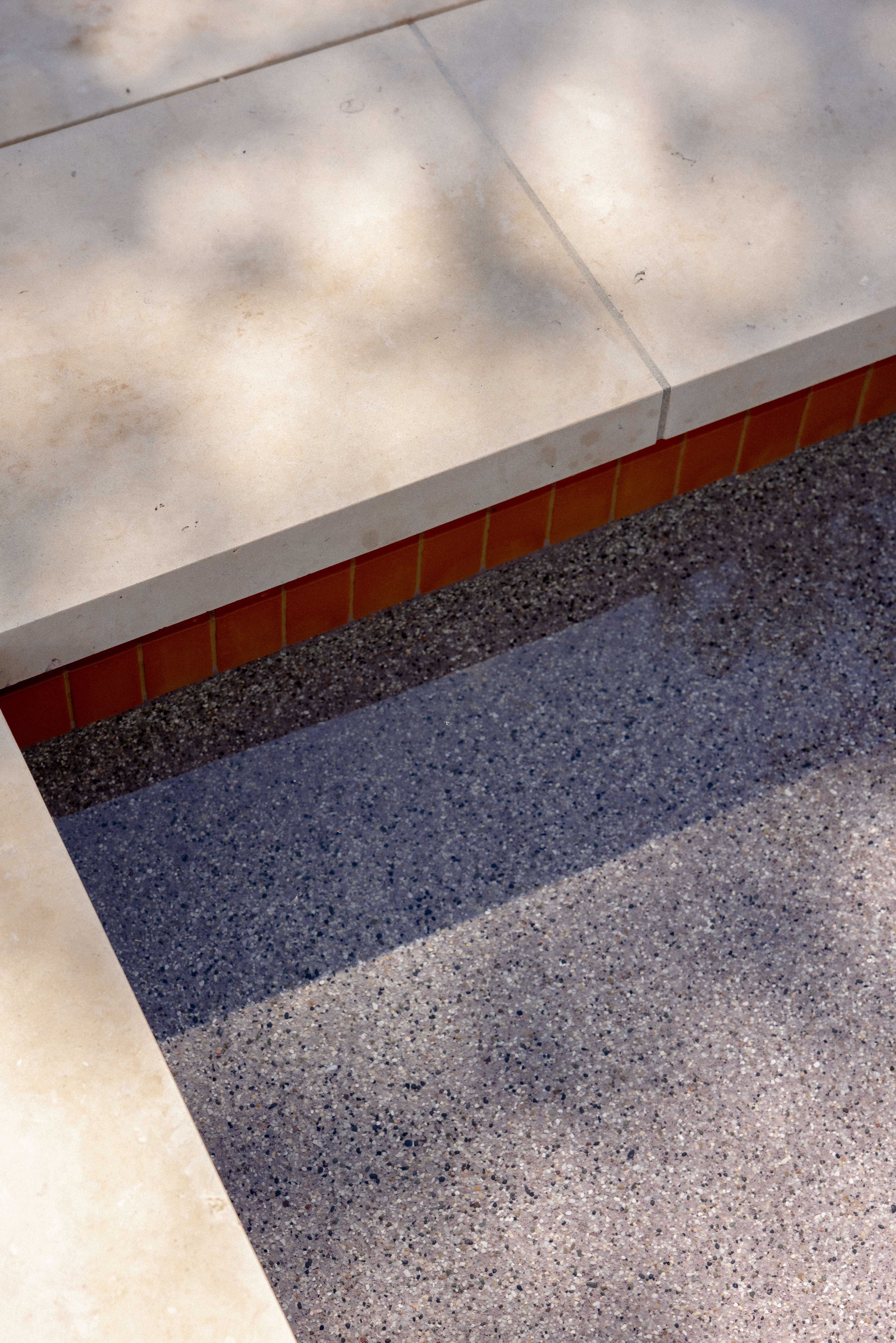 Golden Hour Pools Classic in Dripping Springs, featuring terracotta waterline tile with pebble plaster finish and gunite plaster finish