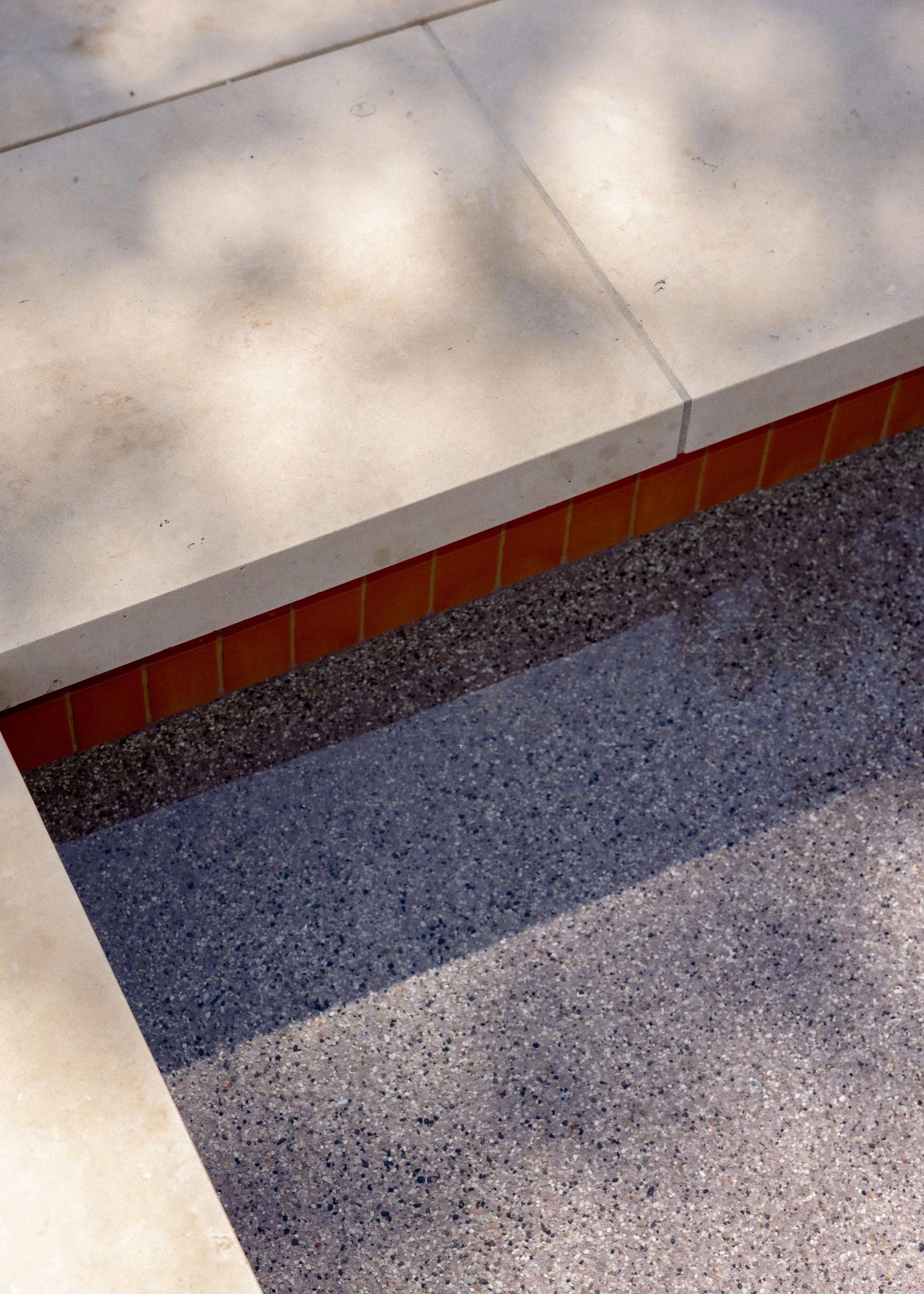 Golden Hour Pools Classic in Dripping Springs, featuring terracotta waterline tile with pebble plaster finish and gunite plaster finish