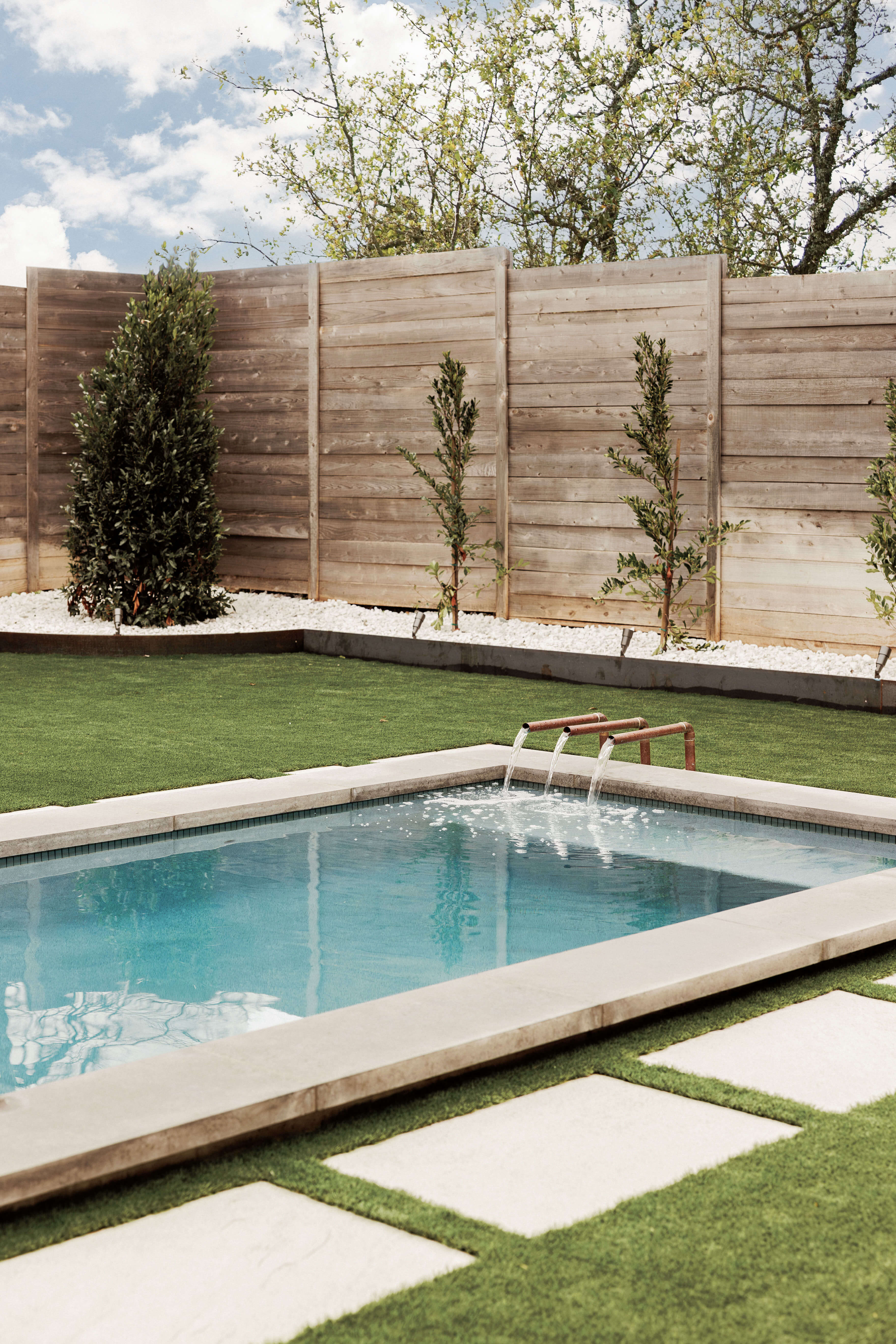 Golden Hour Pools Mini in Dallas, featuring mini pool with fountain and lawn and gunite plaster finish