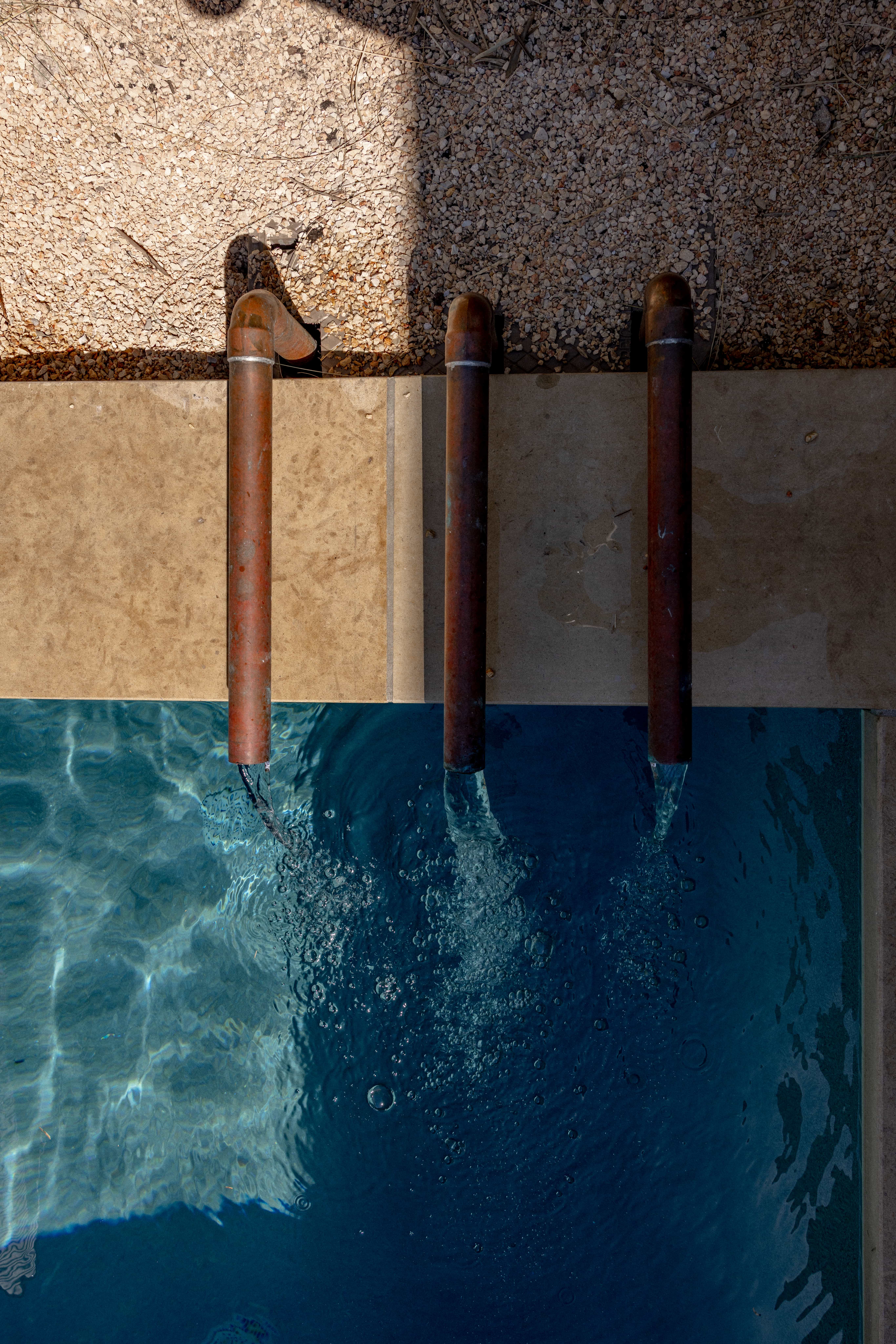 Golden Hour Pools Classic in Austin, featuring fountain trio and waterline tile from above and gunite plaster finish