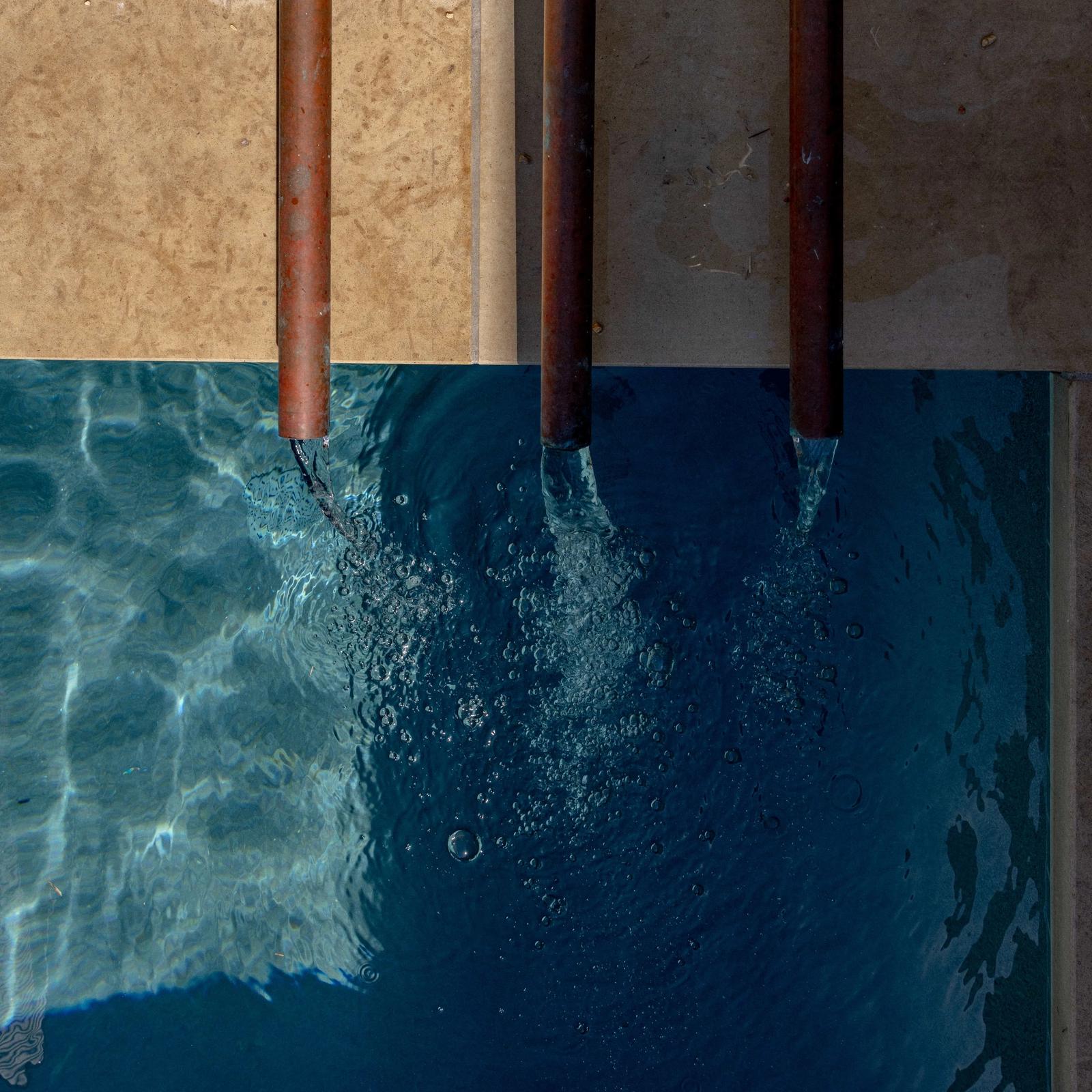 Golden Hour Pools Classic in Austin, featuring fountain trio and waterline tile from above and gunite plaster finish