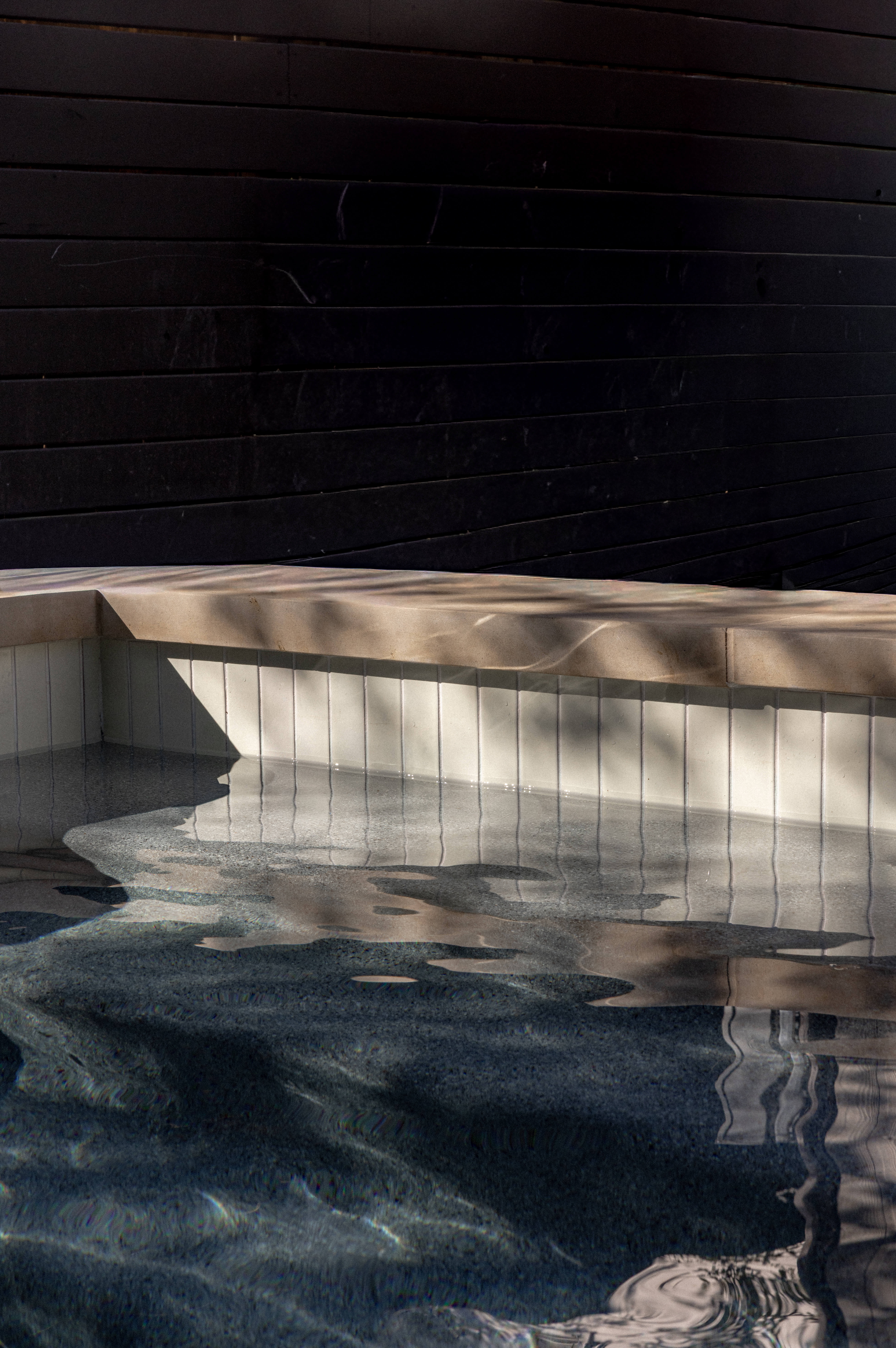 Golden Hour Pools Classic in Austin, featuring light and shadow on water surface and gunite plaster finish