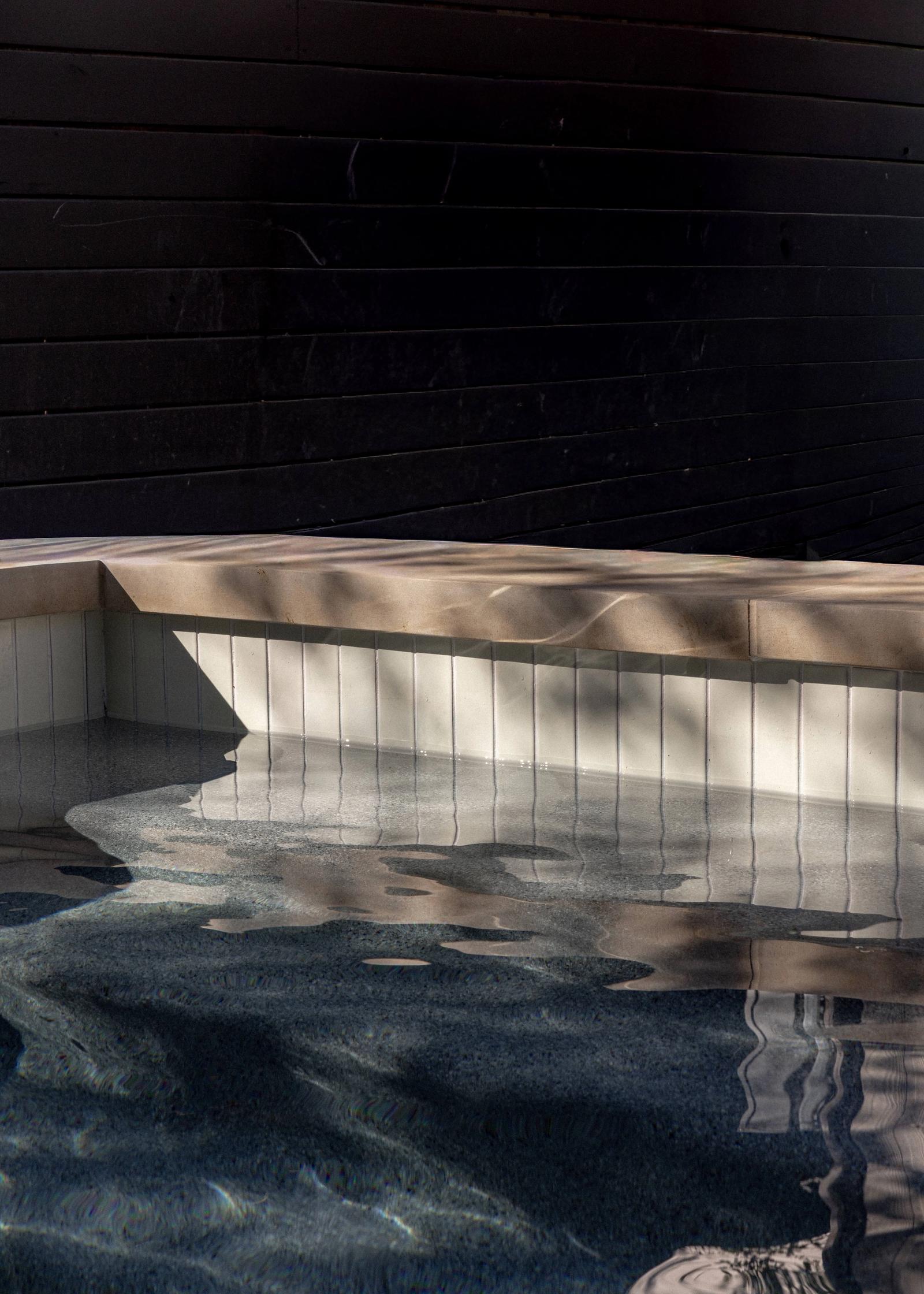 Golden Hour Pools Classic in Austin, featuring light and shadow on water surface and gunite plaster finish