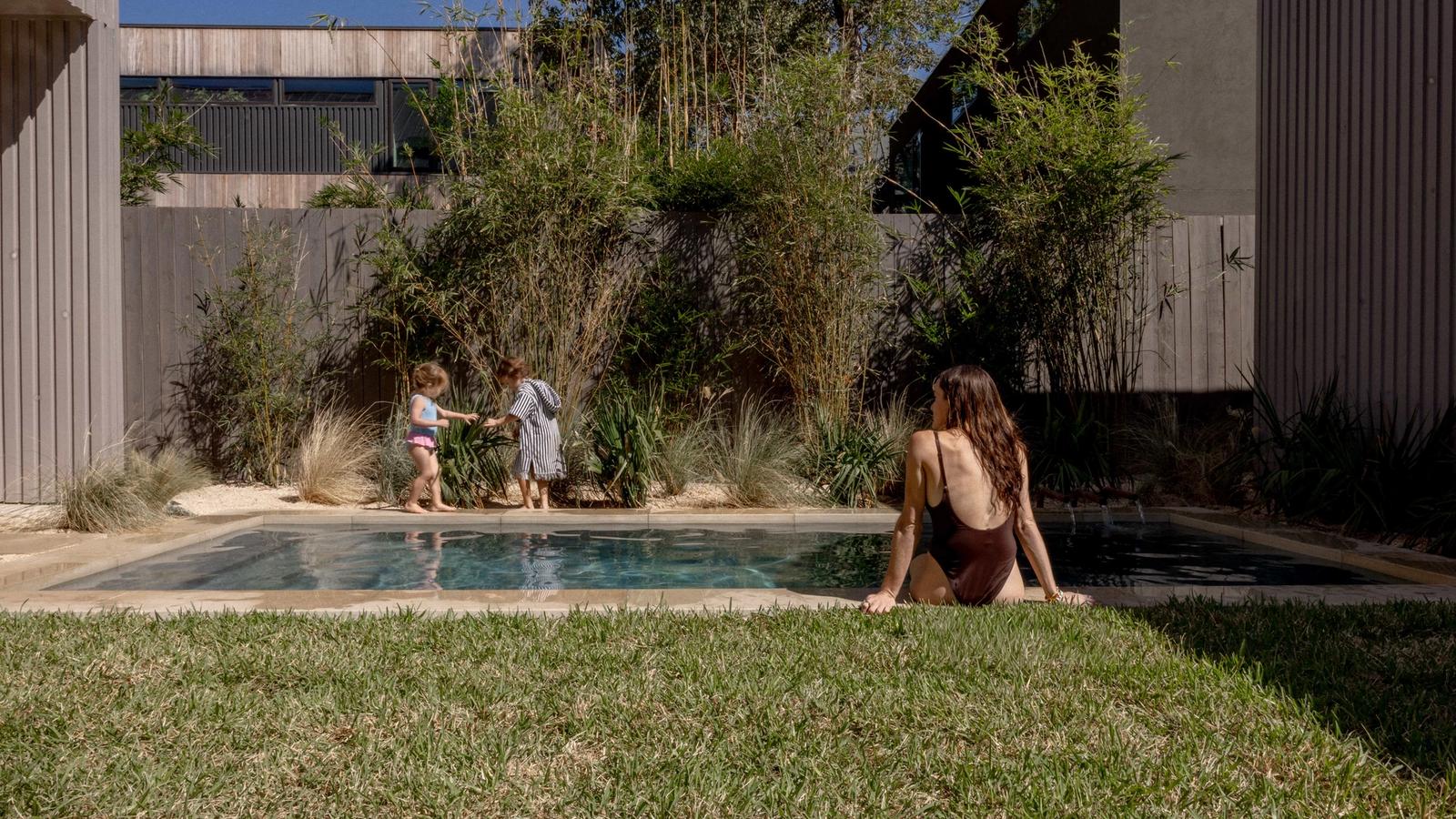 Golden Hour Pools Classic in Austin, featuring family moment with kids and bamboo garden and gunite plaster finish