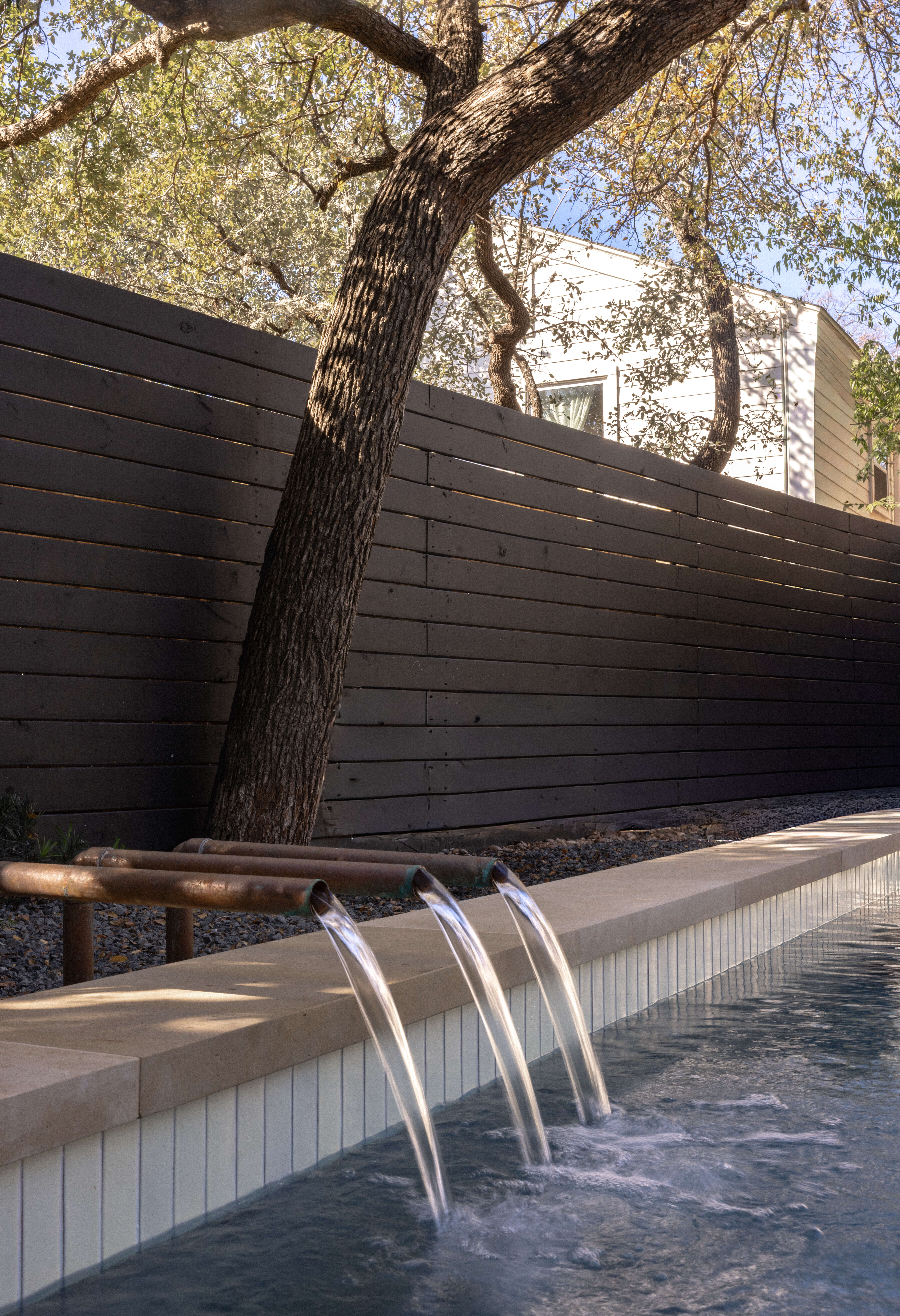 Golden Hour Pools Classic in Austin, featuring dark aesthetic with modern lines and gunite plaster finish
